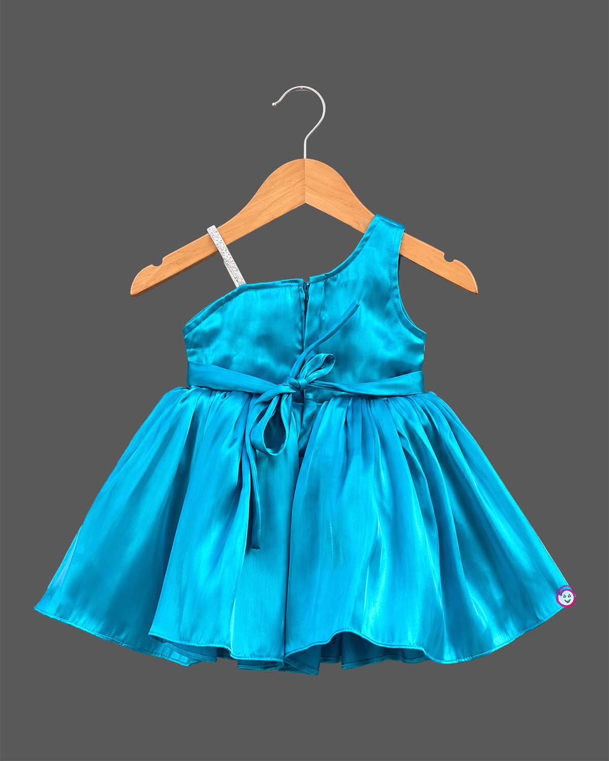 Silk frocks for baby girl with asymmetrical one-shoulder cut and beaded floral applique.