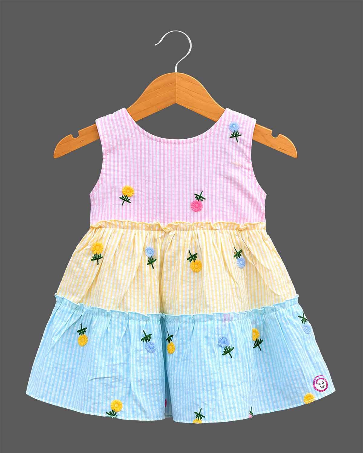 Sleeveless embroidered seersucker tiered frock with scoop neck and frill layers for toddlers.