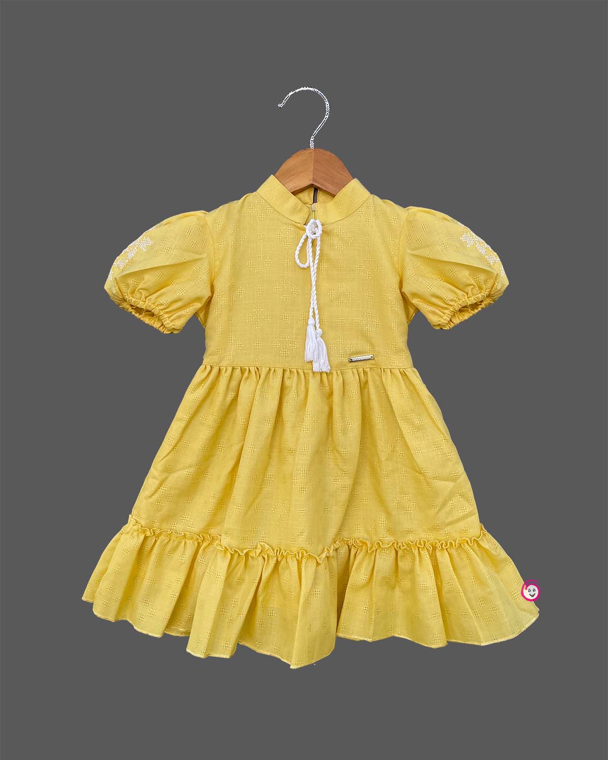 Infant yellow cotton frock with puff sleeves and tassels for family picnic