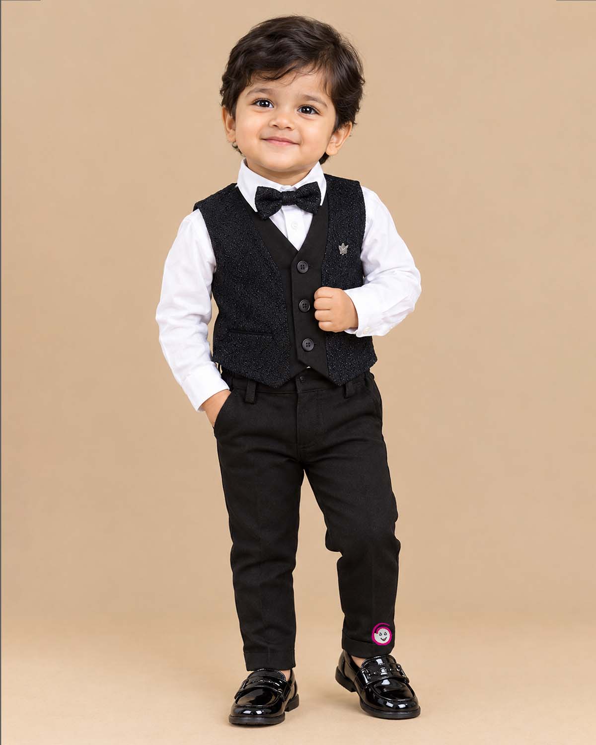 Boys textured layered waistcoat suit set with shirt, bow tie, sleeve roll-up tabs, and pant.