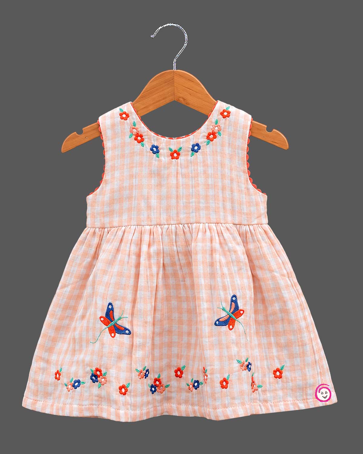 Infant gingham checkered frock featuring butterfly embroidery and sleeveless cut