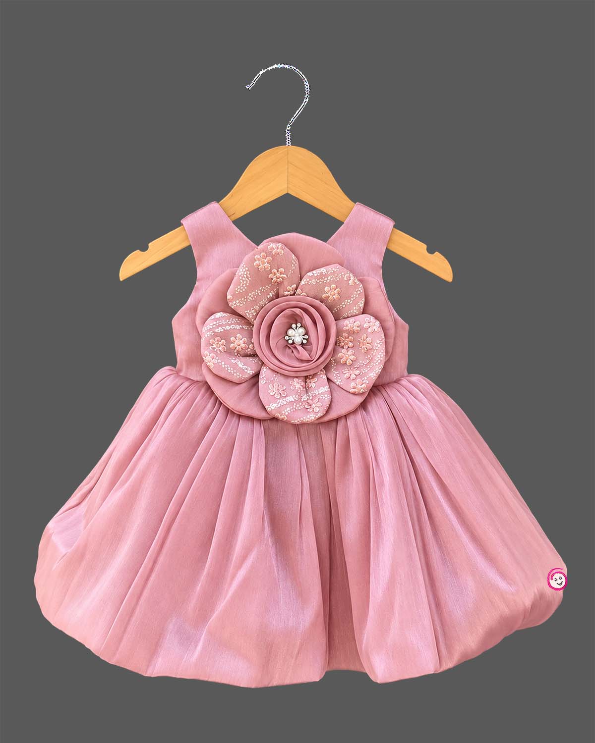 Dusty rose pink toddler net party frock featuring a large floral applique and sleeveless design for girls.