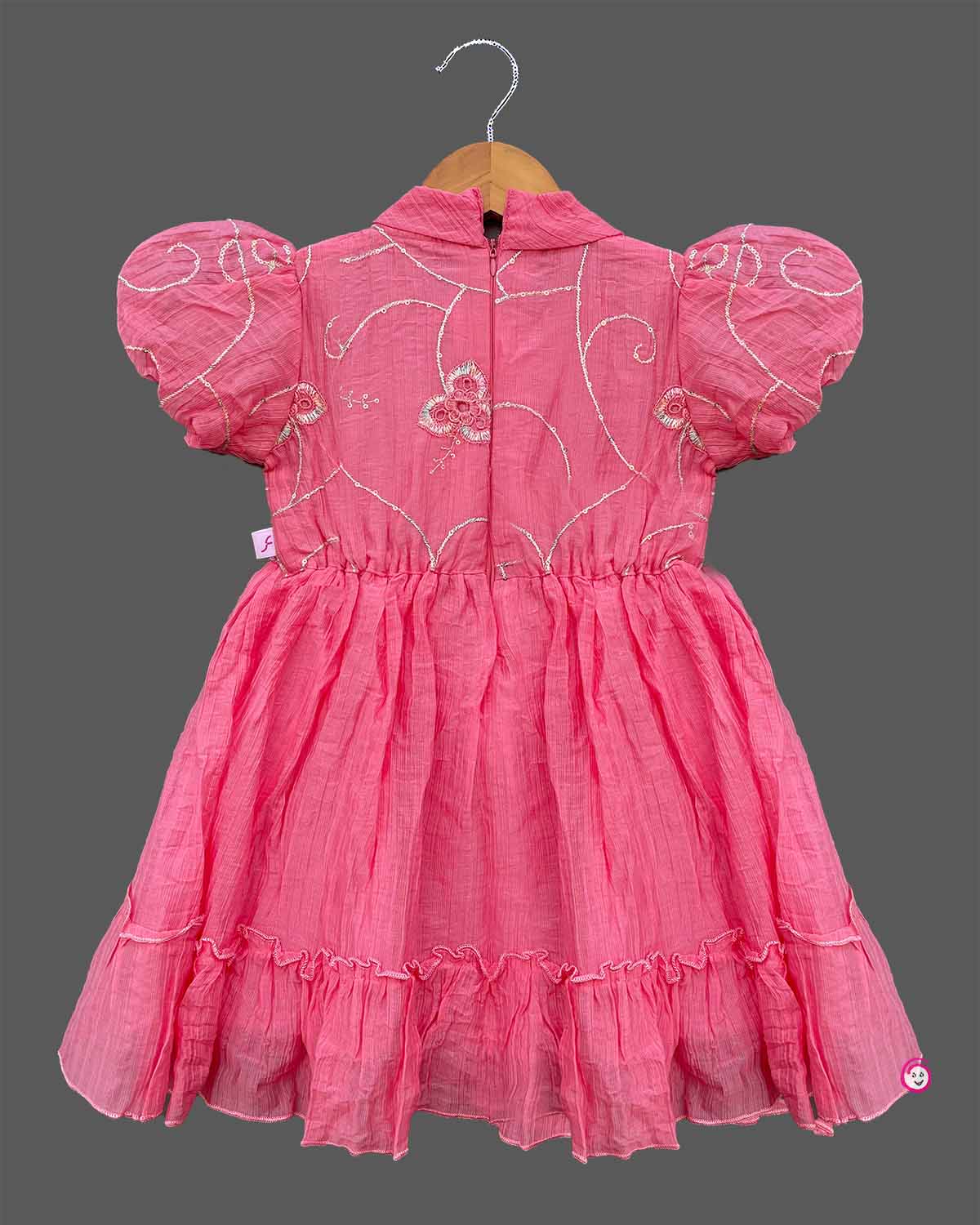 Pink georgette frock with white embroidery and puff sleeves for baby girls