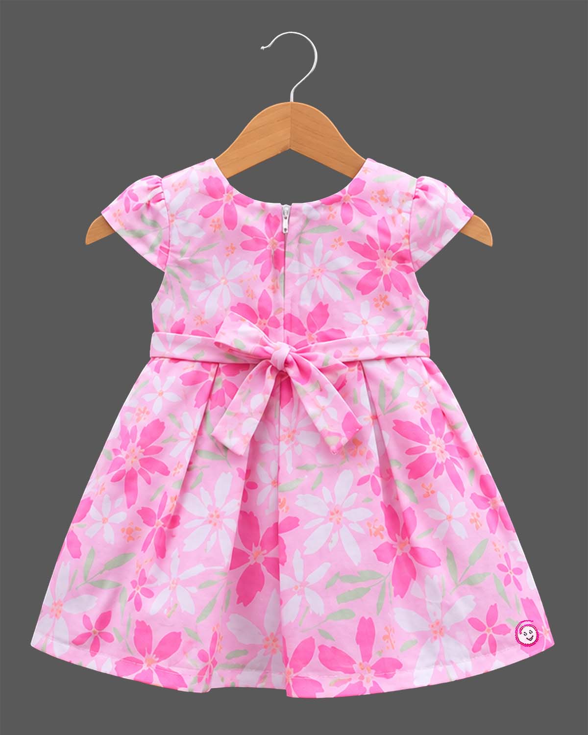 Girls floral box pleated frock with cap sleeves, round neck, and embellished buckle waist belt.