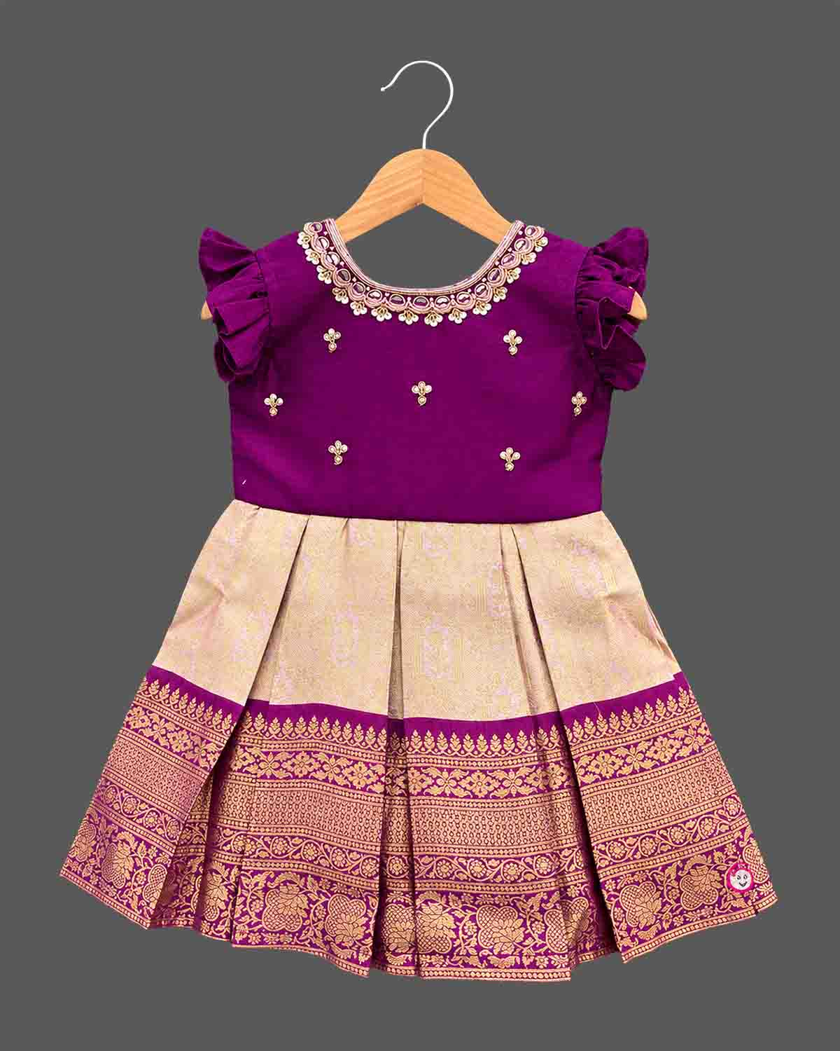 Girls embellished silk frock with embroidered round neck flutter sleeves and pleated zari skirt