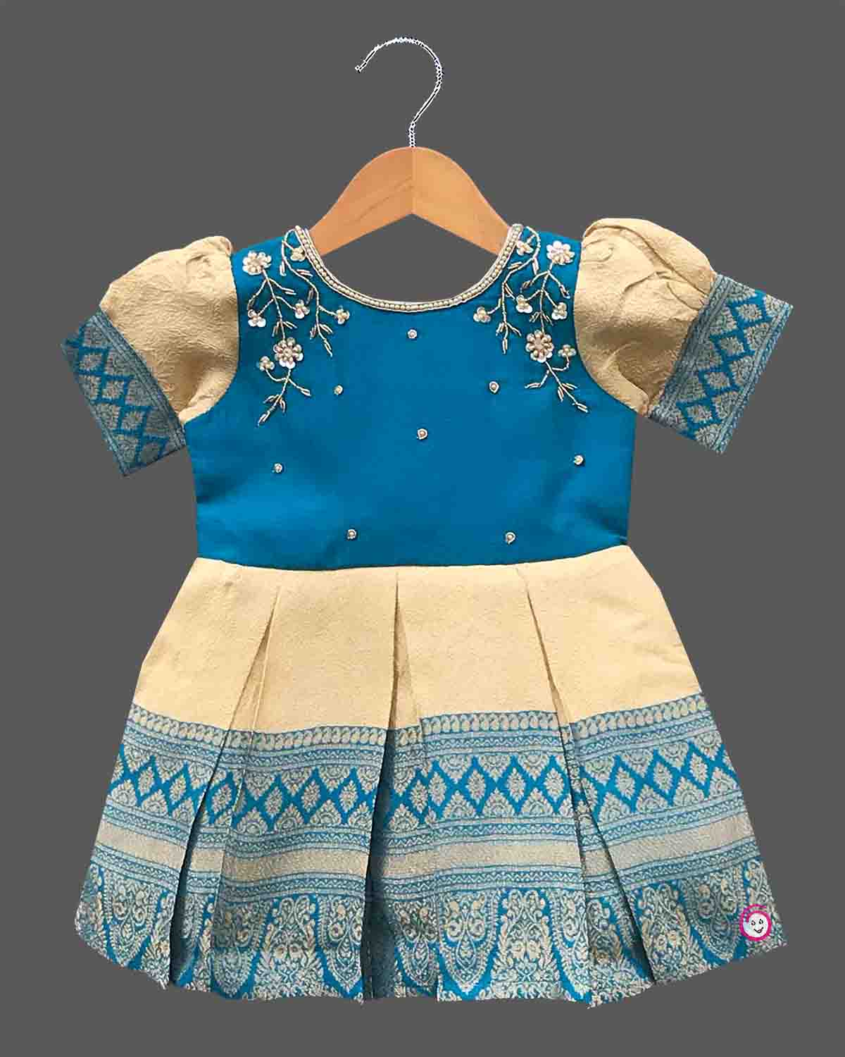 Kids silk ethnic frock featuring floral hand embroidery and woven zari border for traditional parties