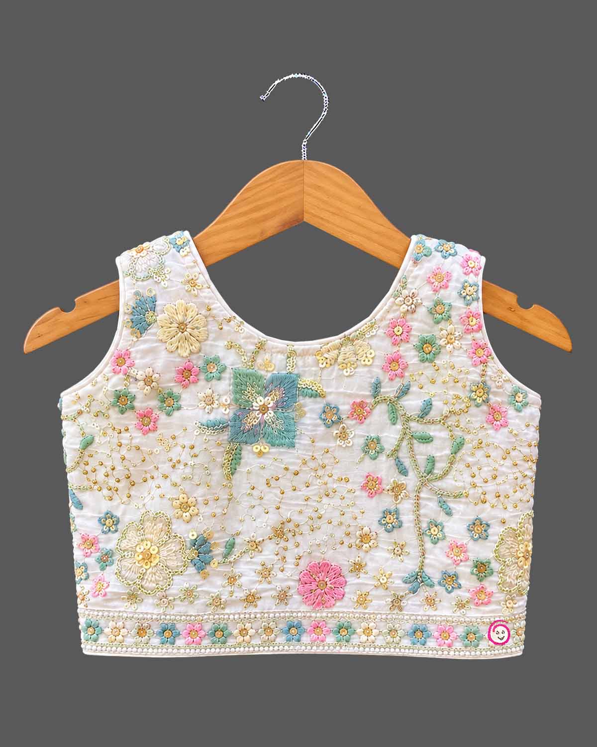 Hand-embroidered lehenga choli for kids with sleeveless choli, flared skirt, and dupatta.