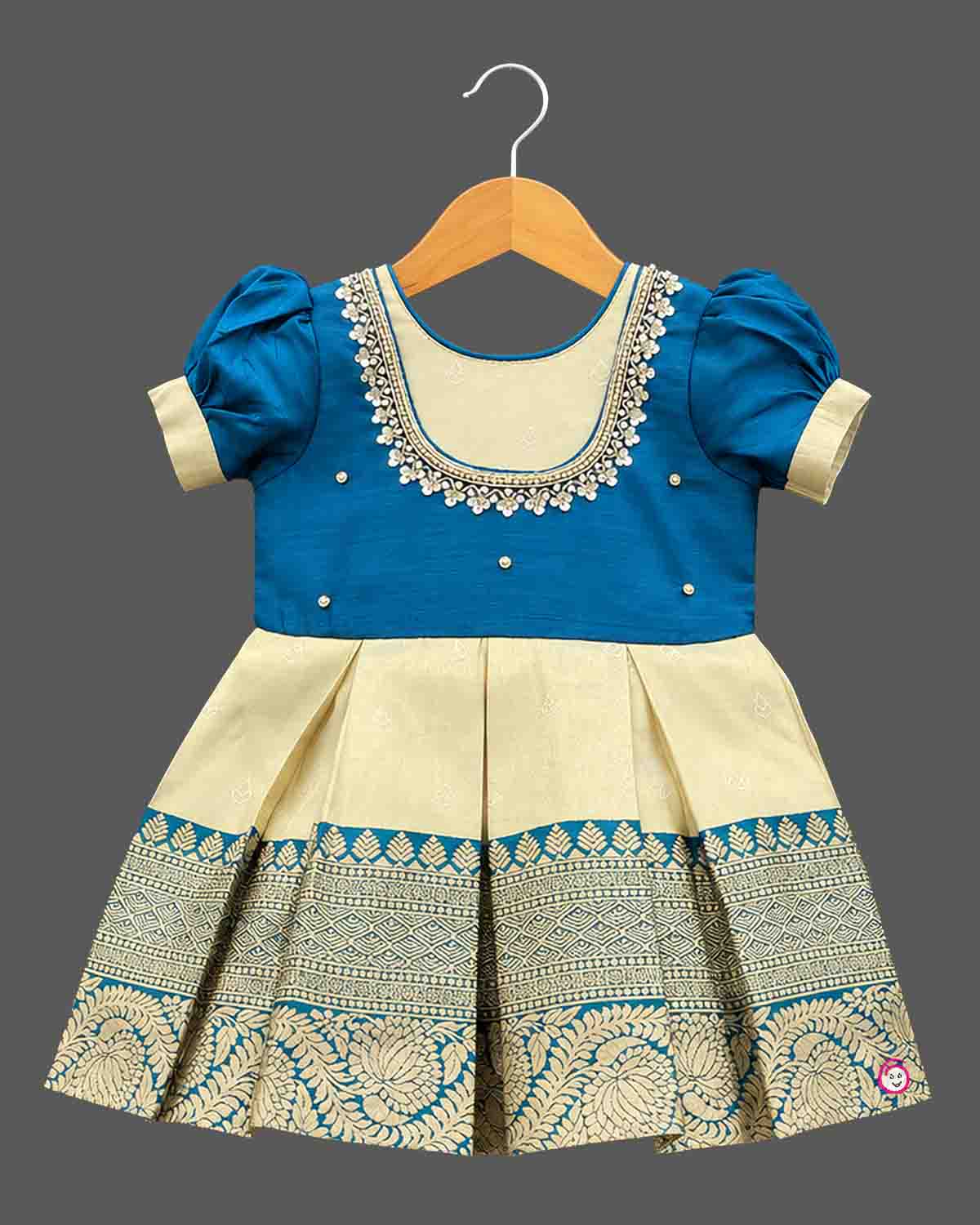 Toddler kids silk cotton frock ethic wear featuring embroidered round neck, puffed sleeves, and bordered skirt.