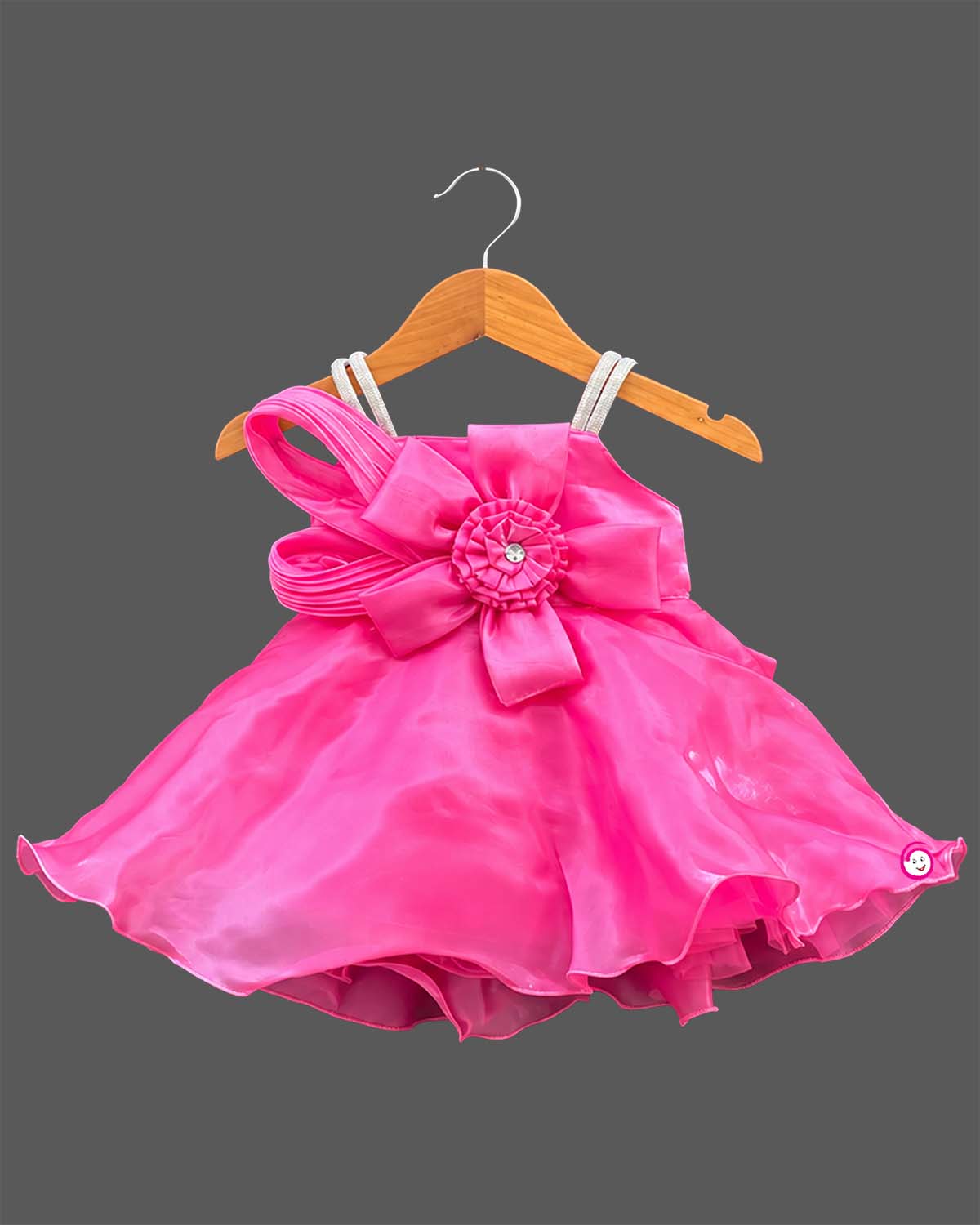Girls organza party frock featuring oversized front bow appliqué and flared hem silhouette.