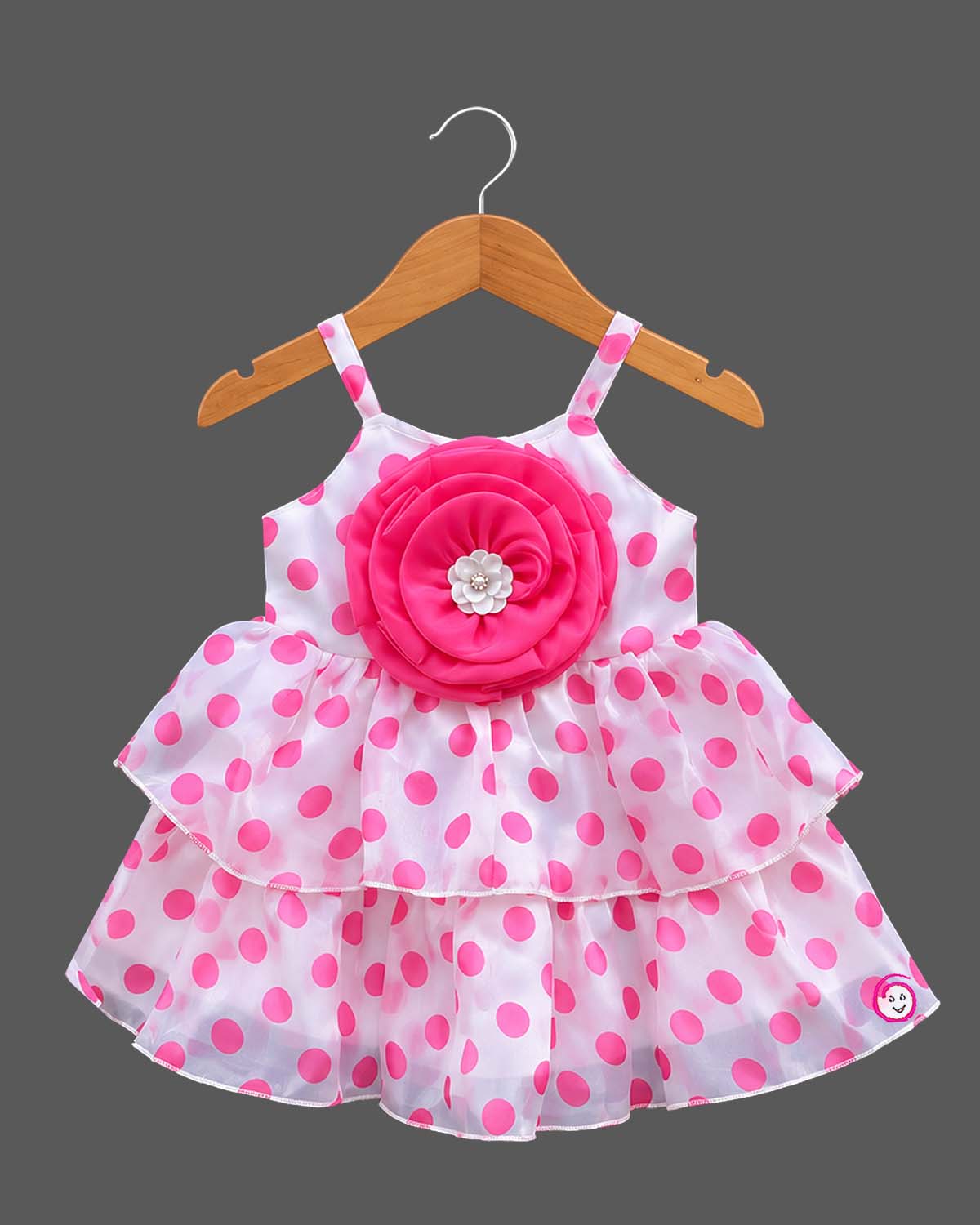 Infant organza casual frock featuring an oversized rosette accent and tiered layers