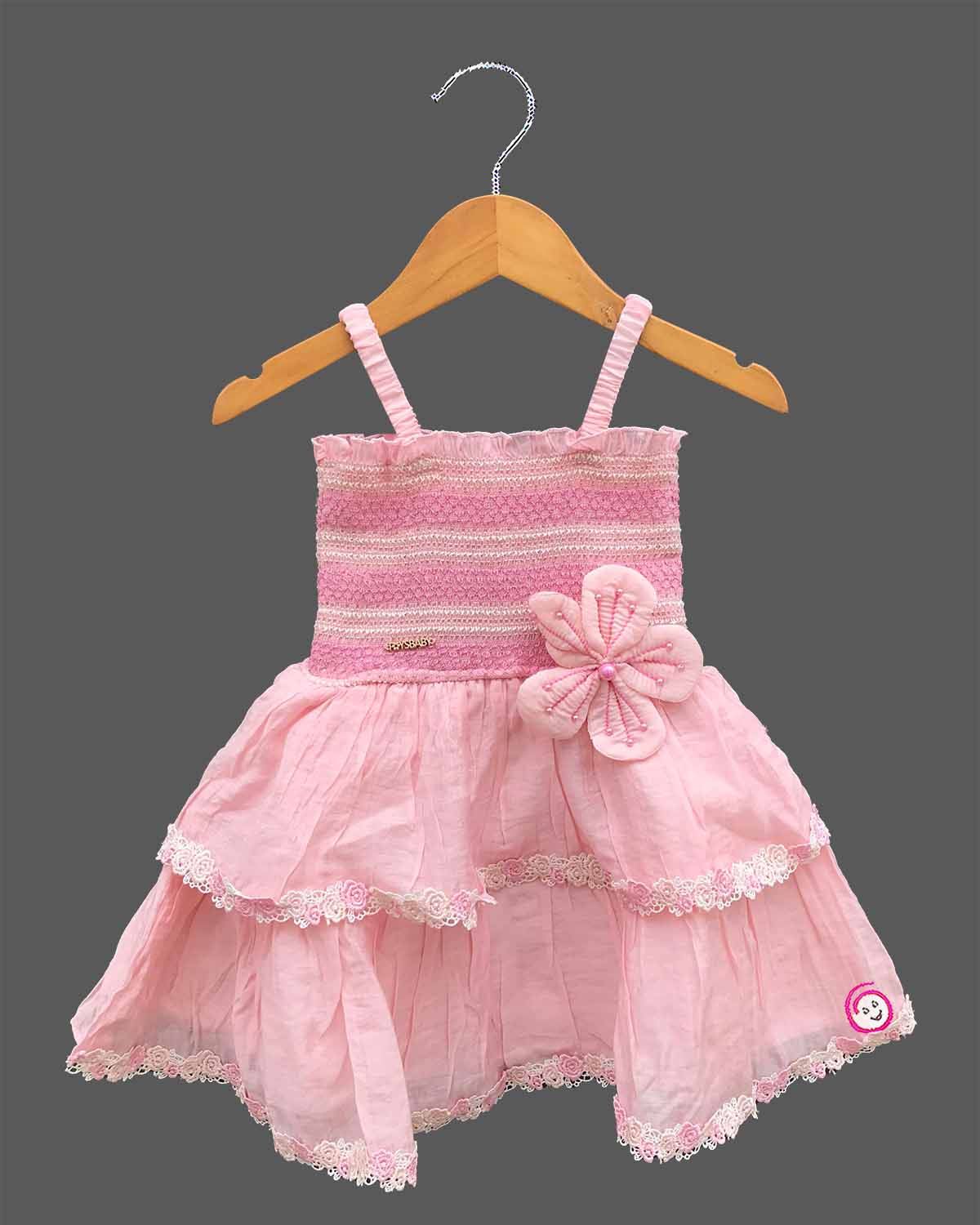 Strapless style smocked bodice frock with detailed flower applique and ruffled lace hem for a little princess