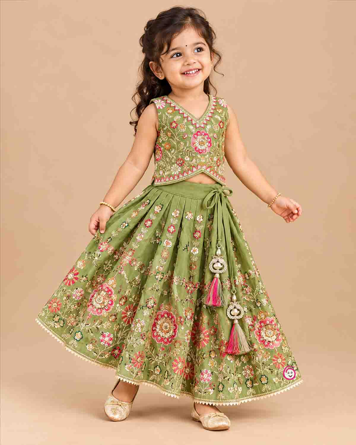 Sleeveless floral embroidered top with curved V-hem and matching pleated choli for kids skirt with sequin work.