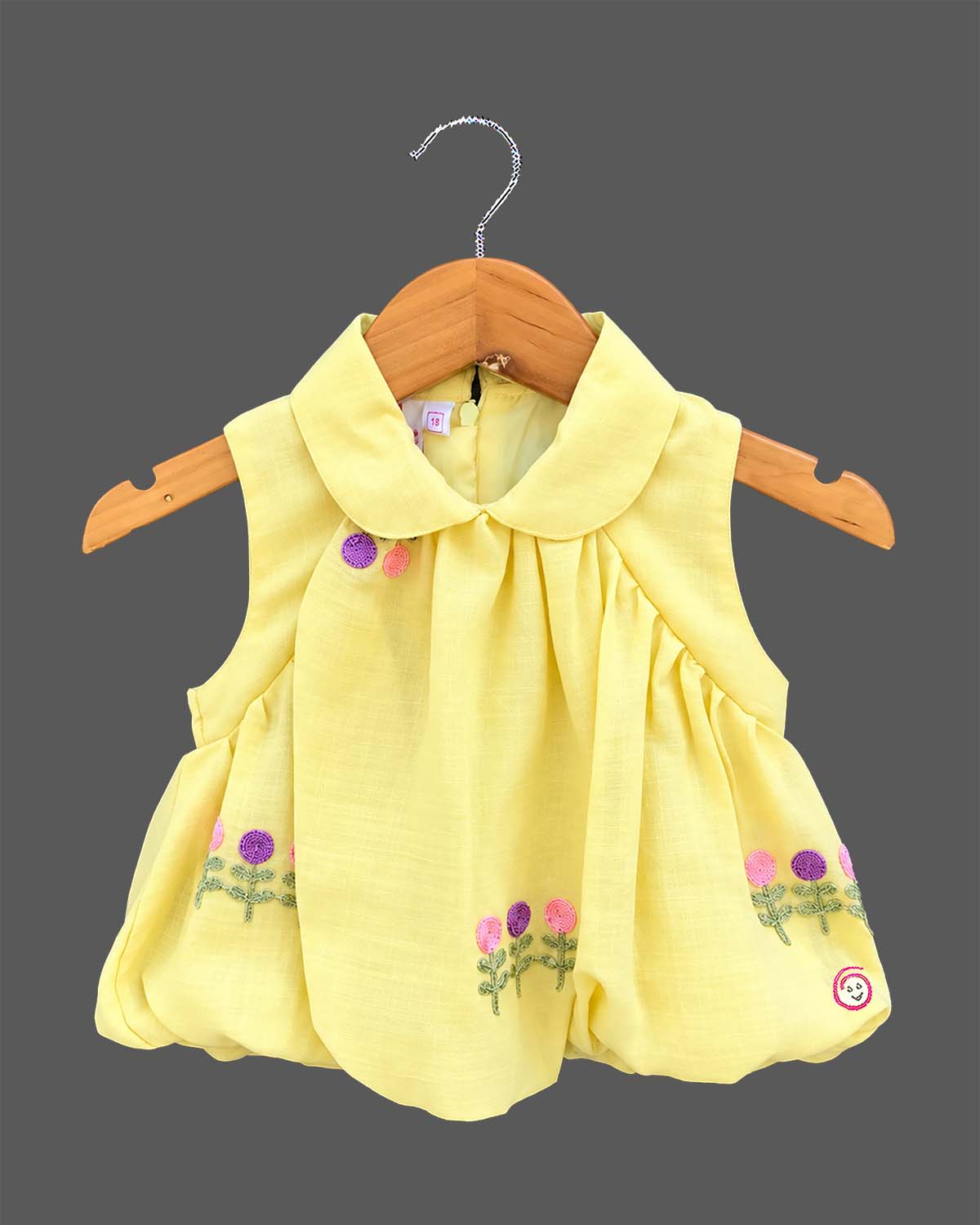 Sleeveless peter pan collar bubble top with floral embroidery paired with matching straight pant