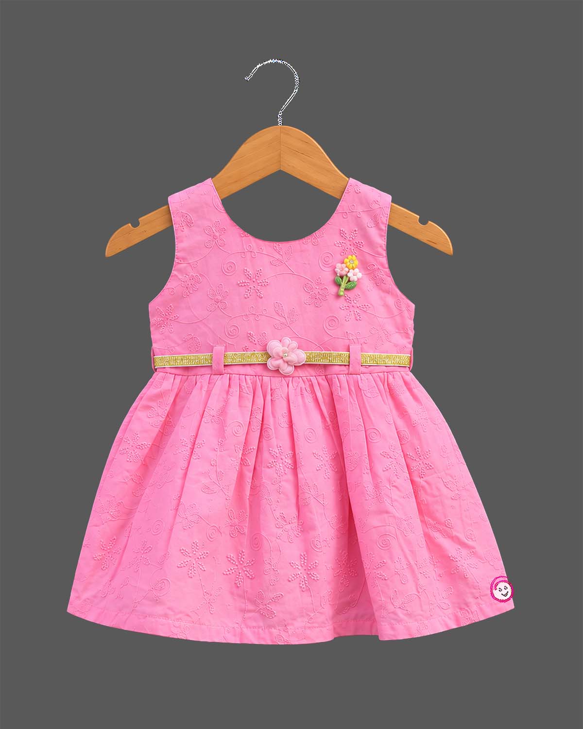 Sleeveless embroidered schiffli floral A-line frock with waist belt and flower applique for toddler girls.