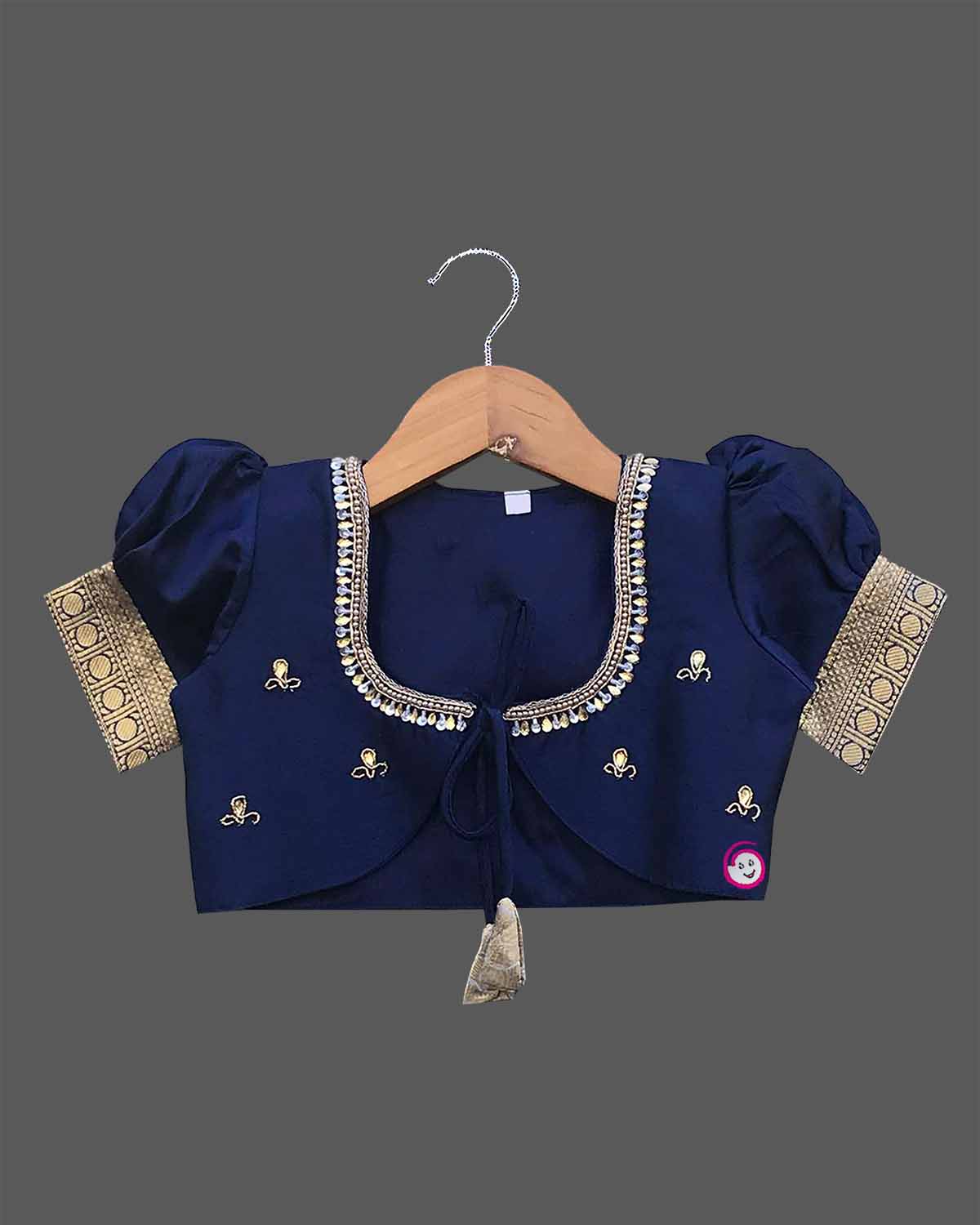 Infant silk cotton frock in cream and navy blue with attached jacket style design, front tie-up tassels, and a traditional heavy gold zari border