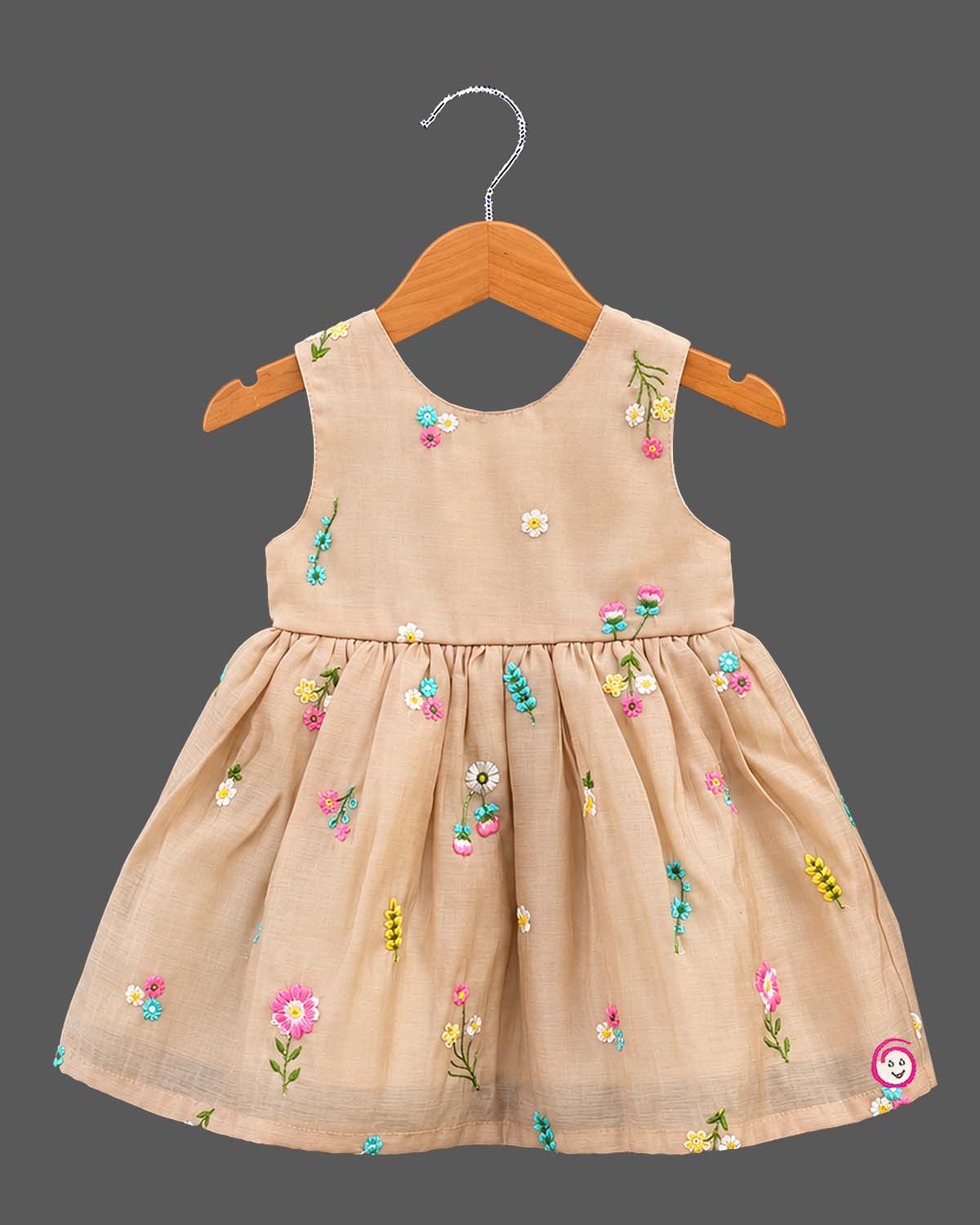 Toddler hand-embroidered sleeveless frock featuring a gathered empire silhouette and scattered floral details