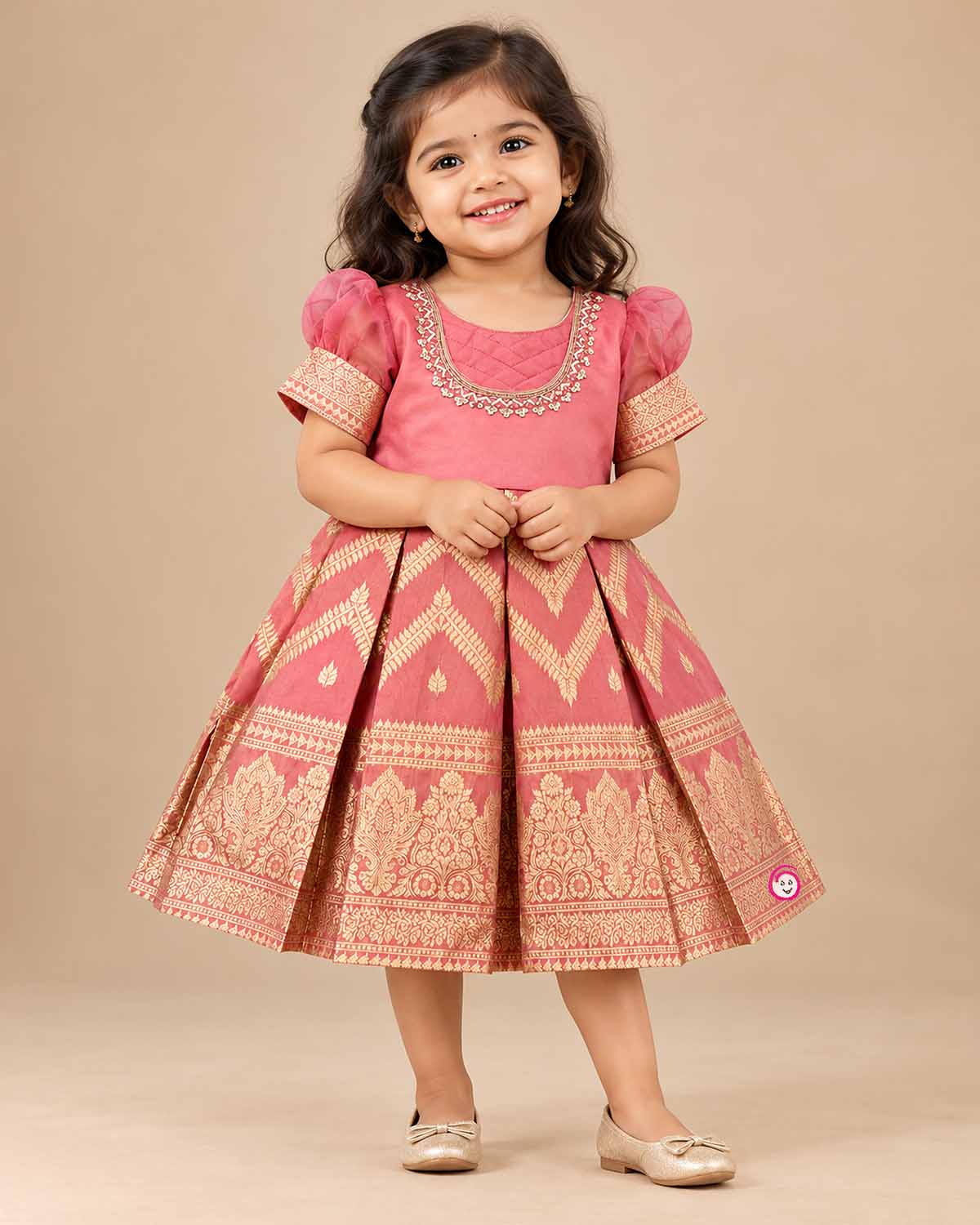 Girls pattu frock with organza puff sleeves, zari chevron box pleats and hand embroidered neckline on a hanger