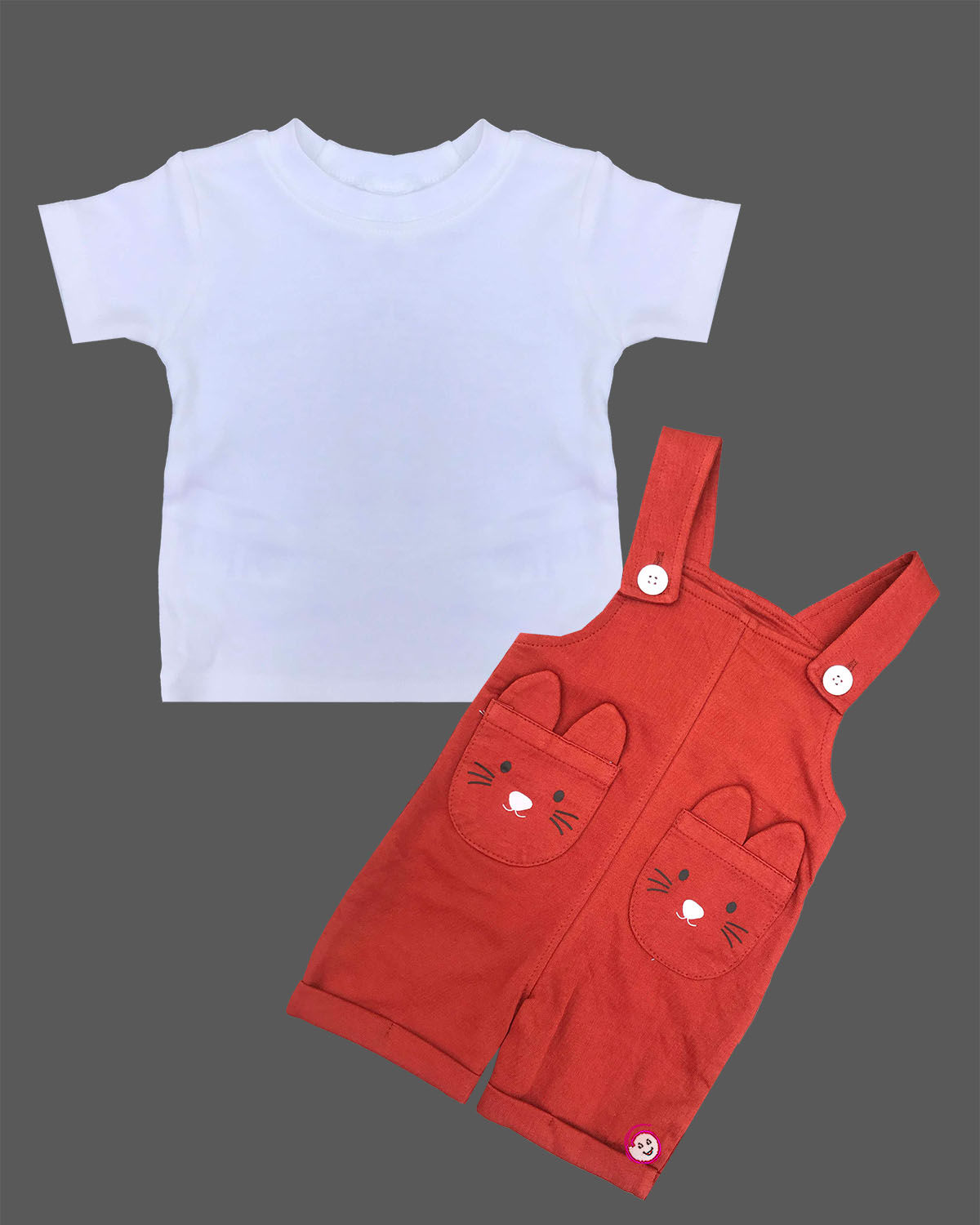 Infant boy wearing soft cotton dungaree shorts set with character face pockets and short sleeve tee.