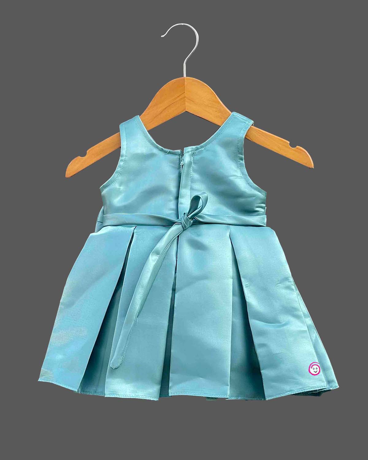 Sleeveless pleated silk frocks for baby girl with oversized waist bow and crystal belt detailing.