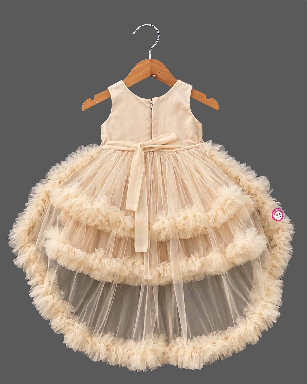 Beige cream net party frock for girls featuring sequin floral embroidery, sleeveless bodice, and tiered ruffle high-low hem design