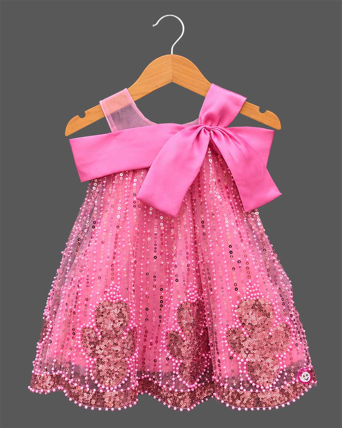 Girls sequin embellished A-line frock with large front satin bow, illusion mesh straps, and pearl beaded trim.