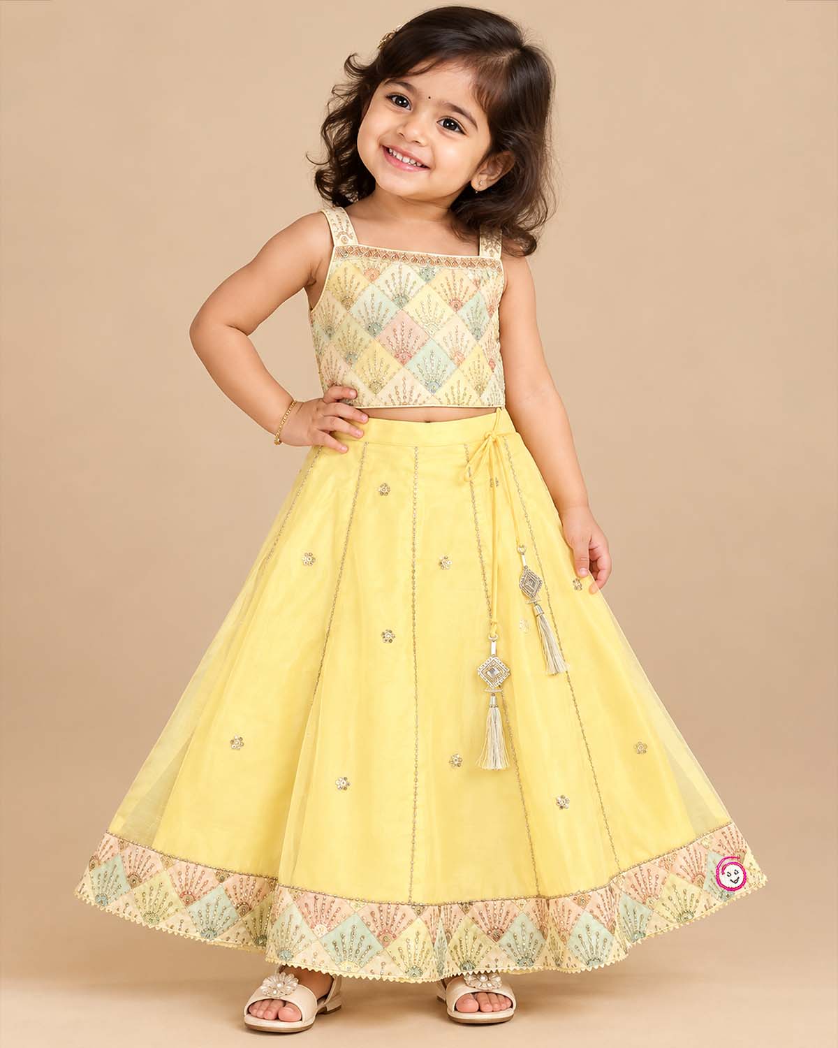 Girls sleeveless embroidered choli with square neck and flared ghagra skirt featuring tassel accents
