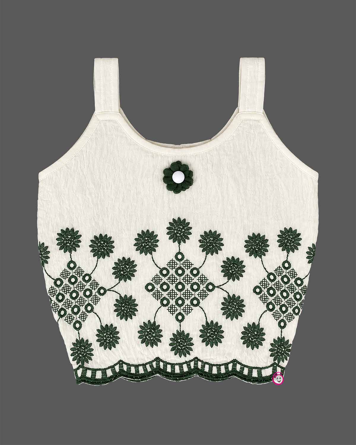 Girls sleeveless embroidered top with scalloped hem paired with pleated cuffed shorts and decorative charm.