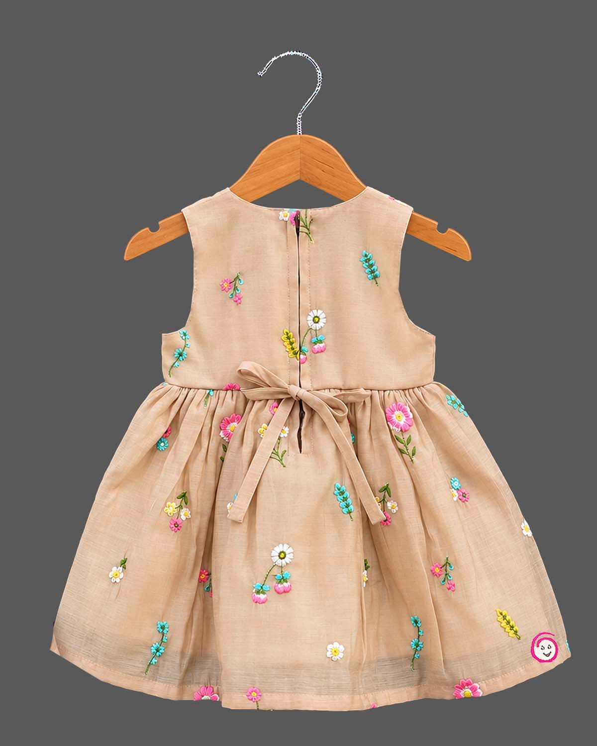 Toddler hand-embroidered sleeveless frock featuring a gathered empire silhouette and scattered floral details