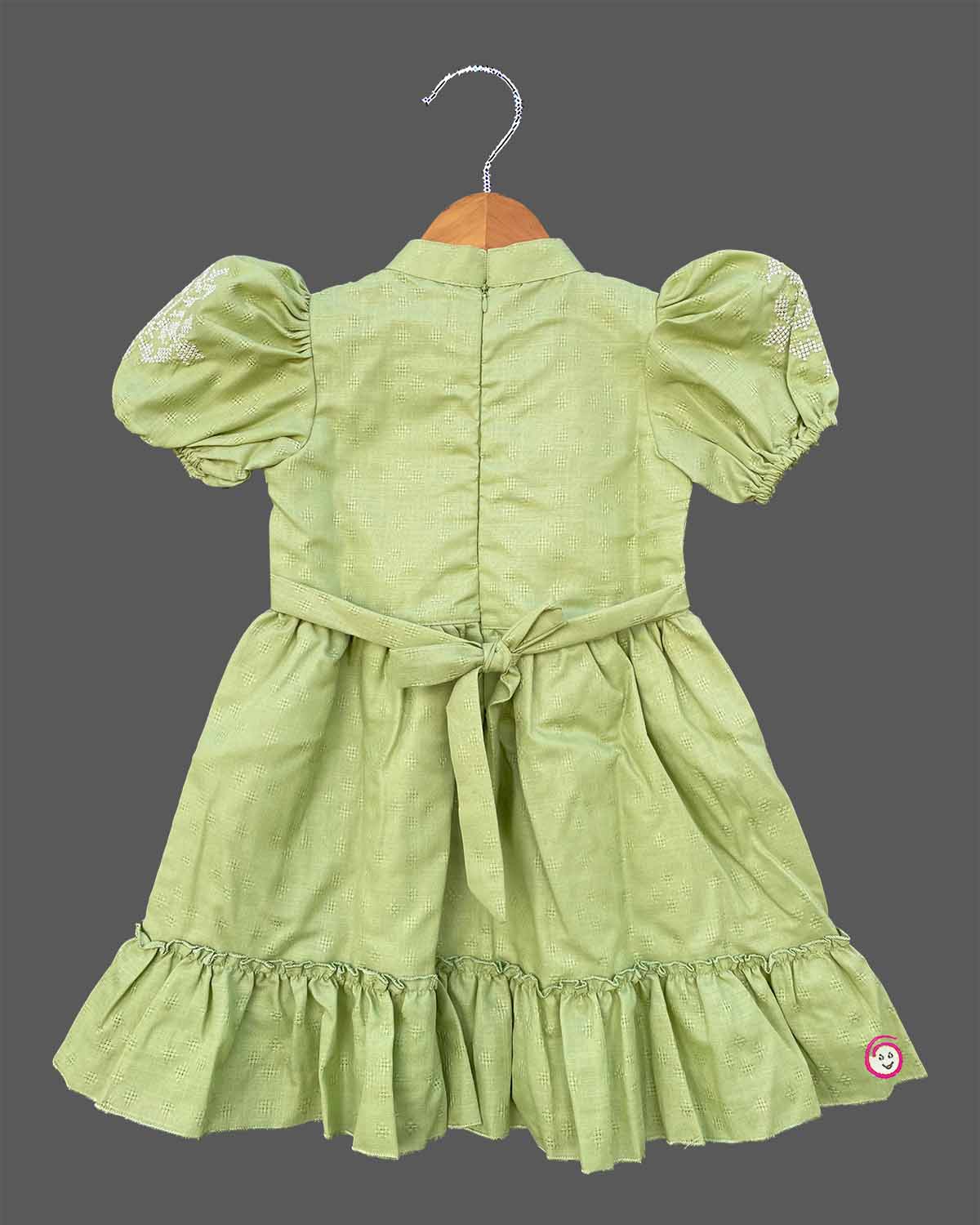 Pistachio green textured cotton girls frock with puff sleeve and tassels