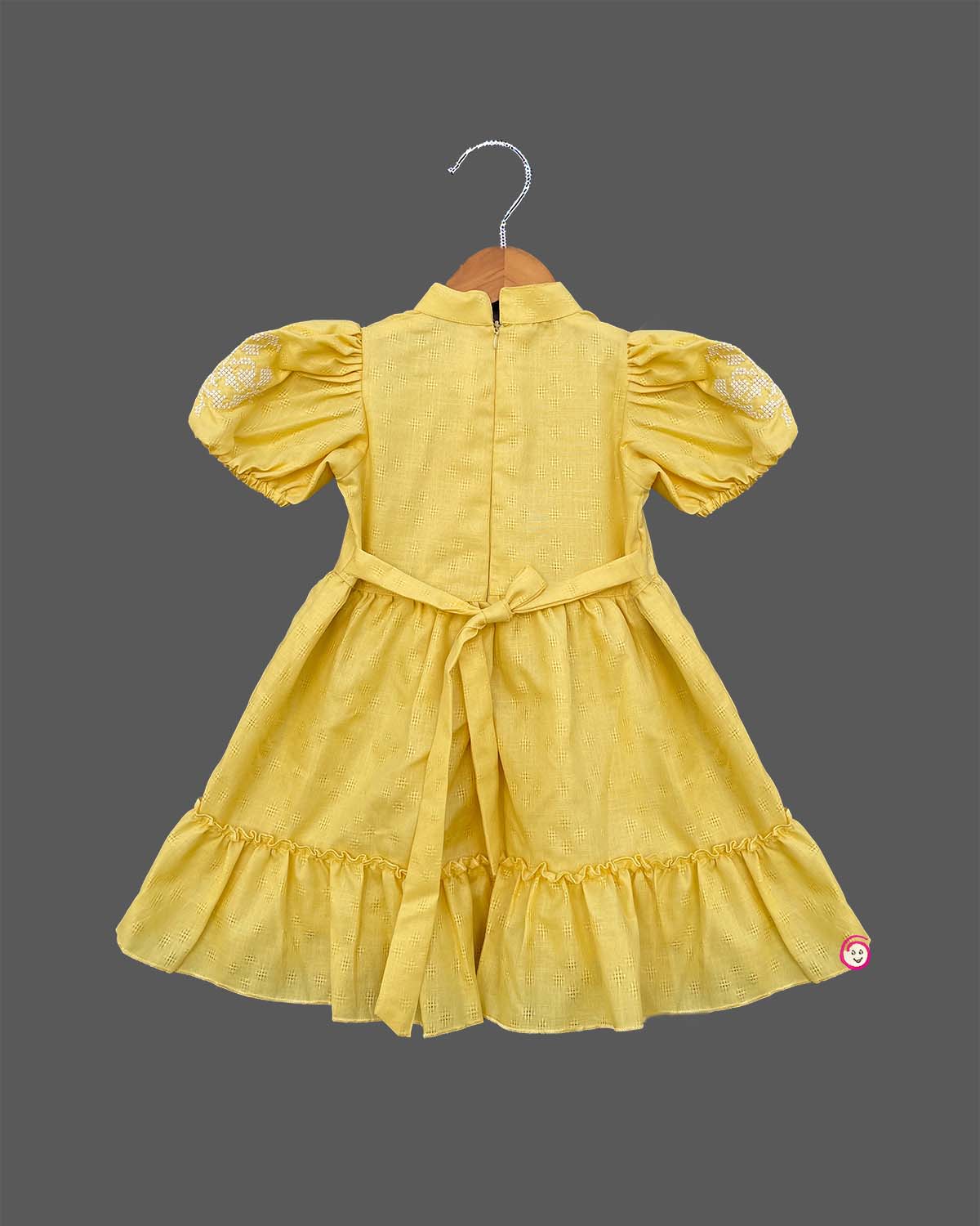 Infant yellow cotton frock with puff sleeves and tassels for family picnic