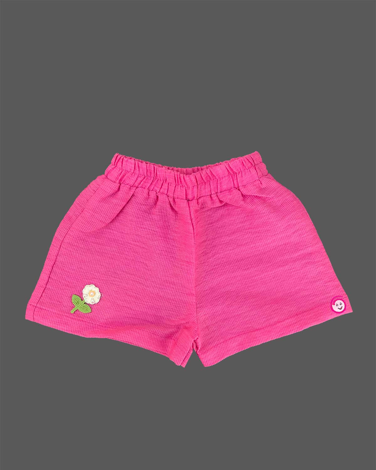 Cream tiered top with pink floral embroidery and bright pink shorts baby girl top and shorts set for summer vacations, playdates, and park outings