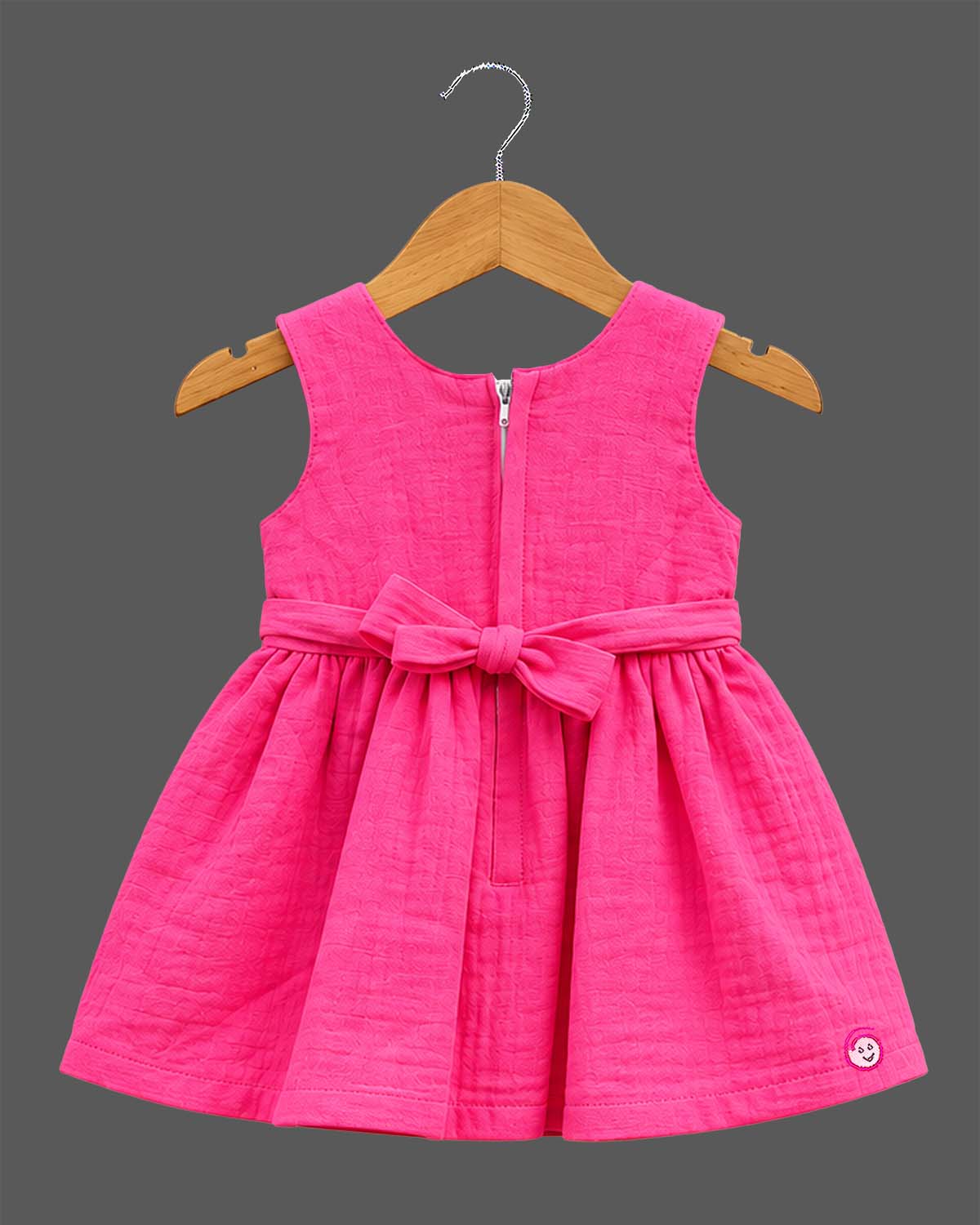 Toddler girls embroidered A-line frock with ruffled neckline, waist bow accents, and sleeveless cut.