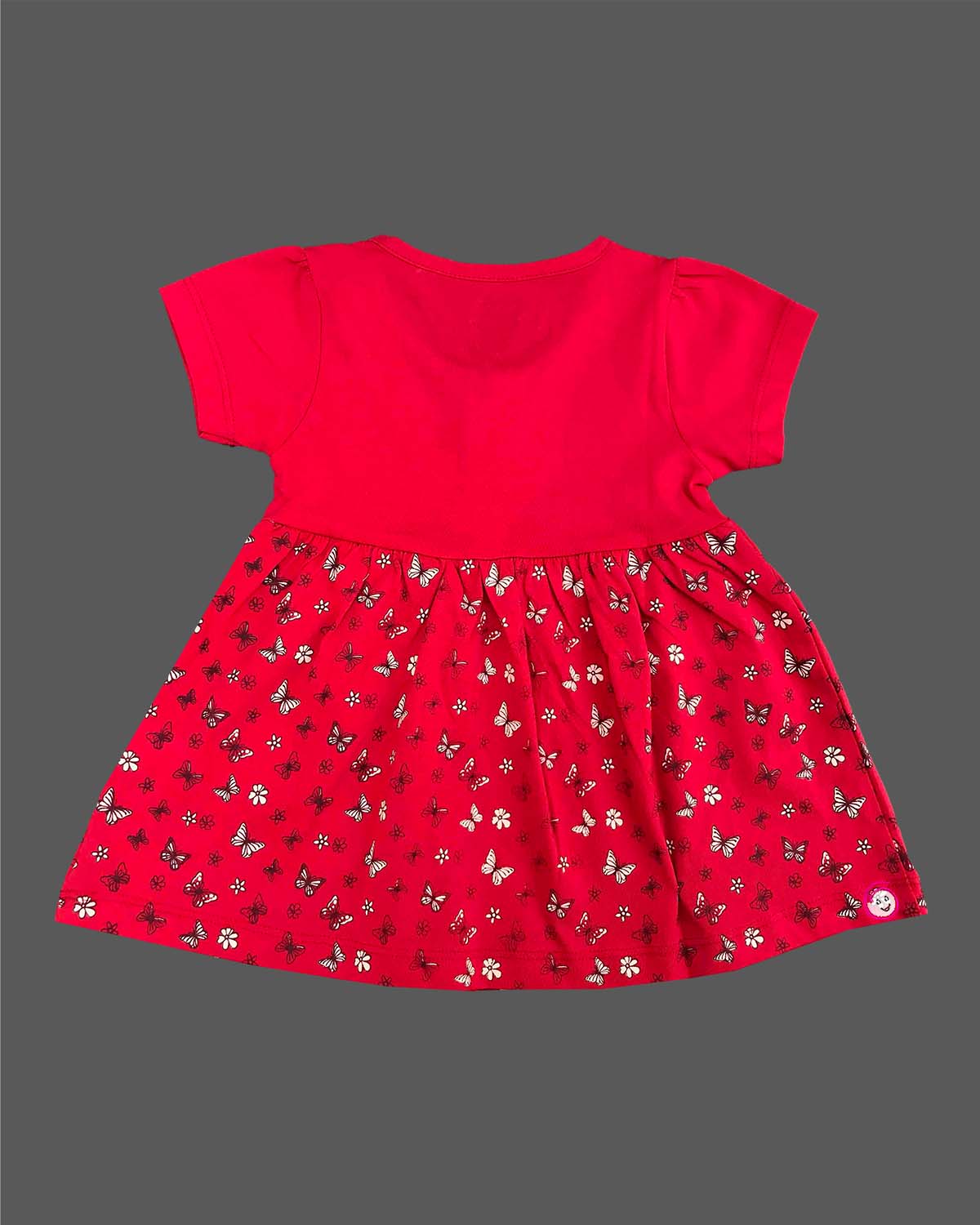 Infants frock with printed flared skirt and button detailing on top for daily casual wear