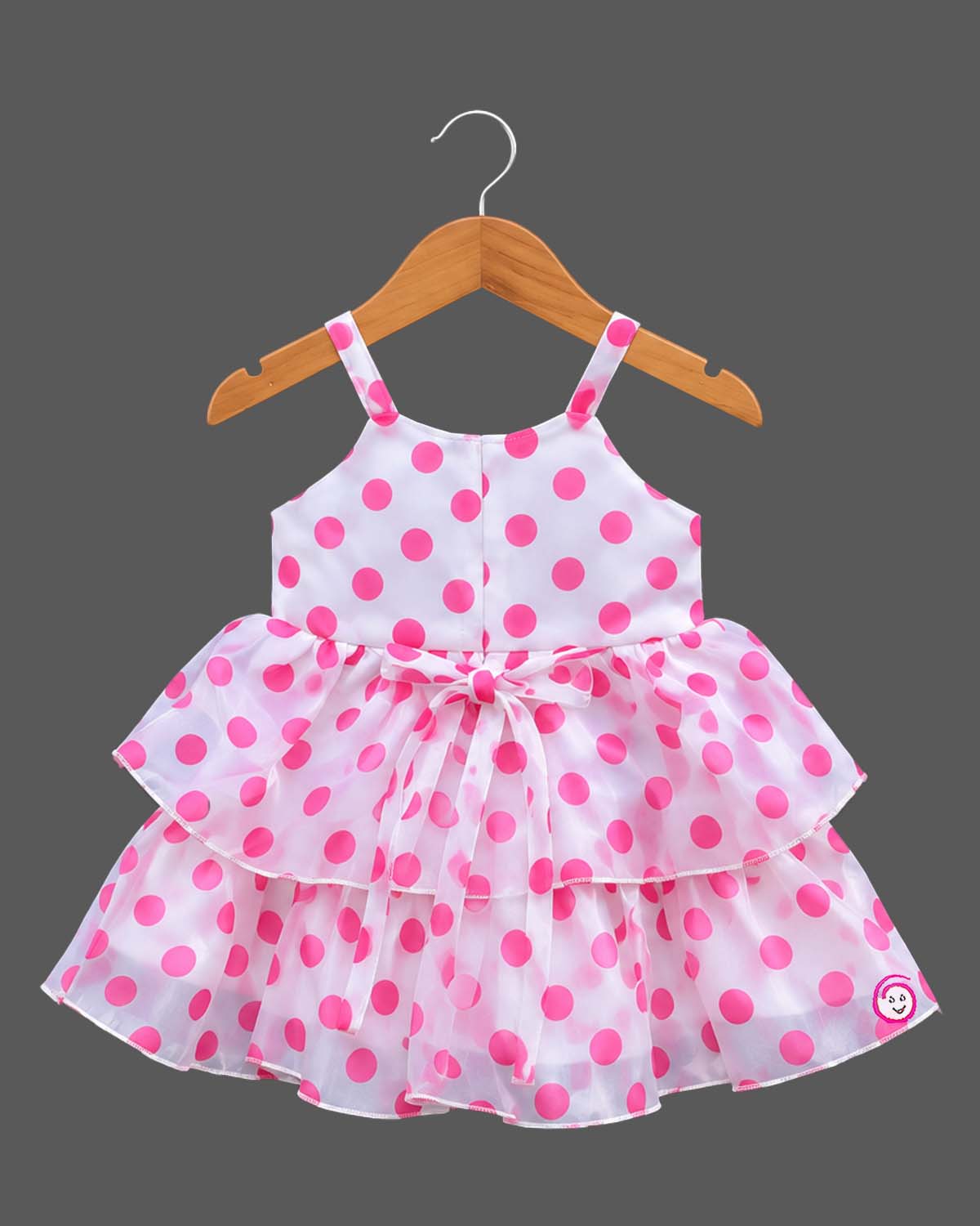 Infant organza casual frock featuring an oversized rosette accent and tiered layers
