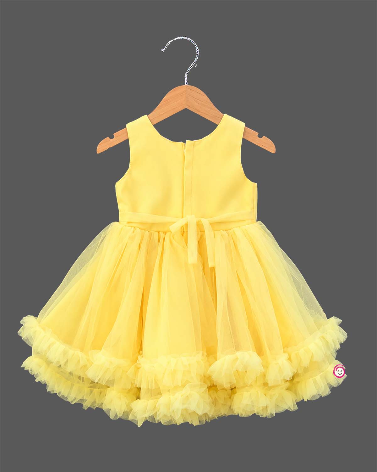Sleeveless pleated bodice tulle frock with ruffled tiered hem and waist floral appliqué accent.