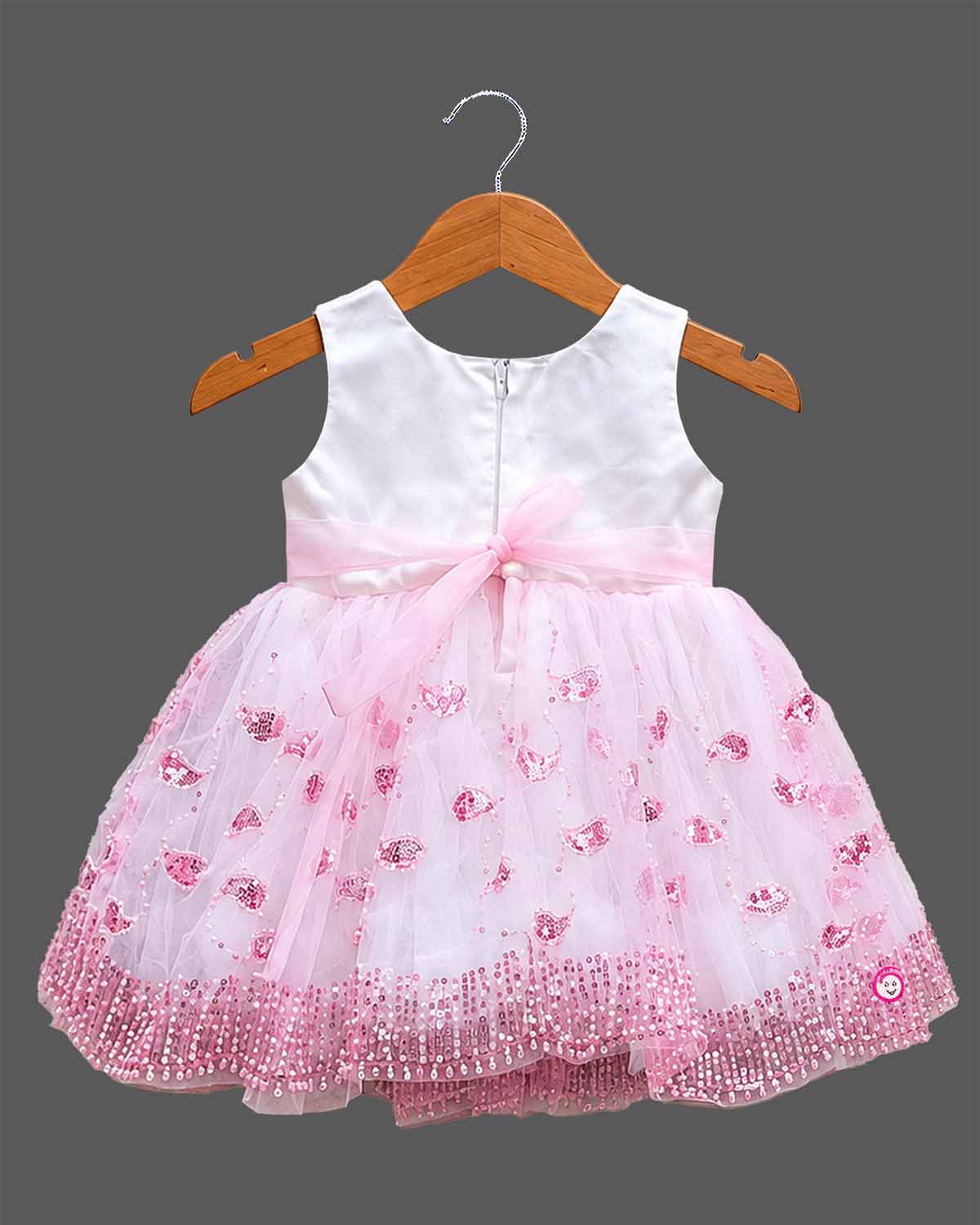 Sleeveless net fit-and-flare girl frock with floral waist appliqué and sequin detailing for parties.