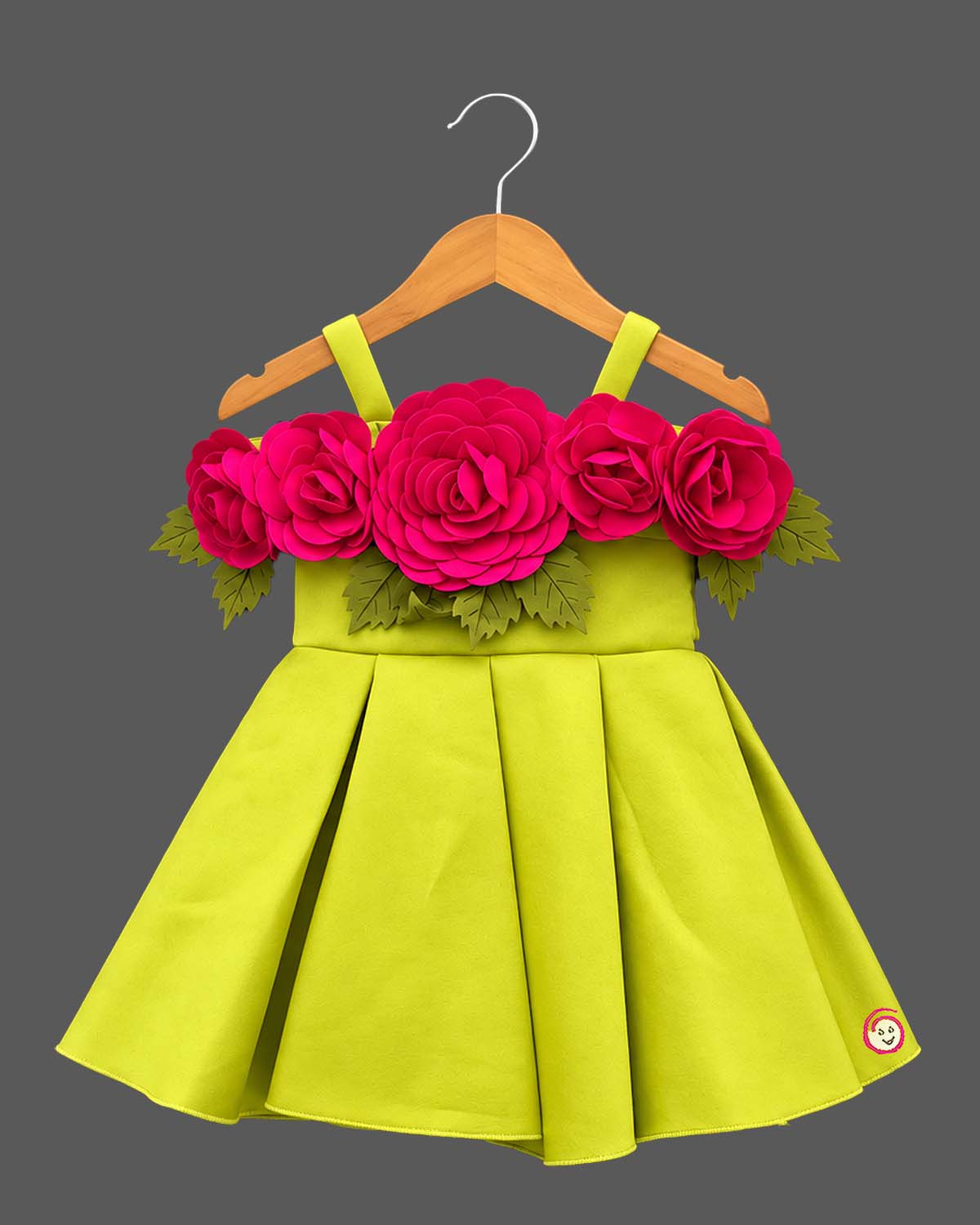 Baby party wear dress featuring oversized floral appliques and structured box pleats on a flared silhouette
