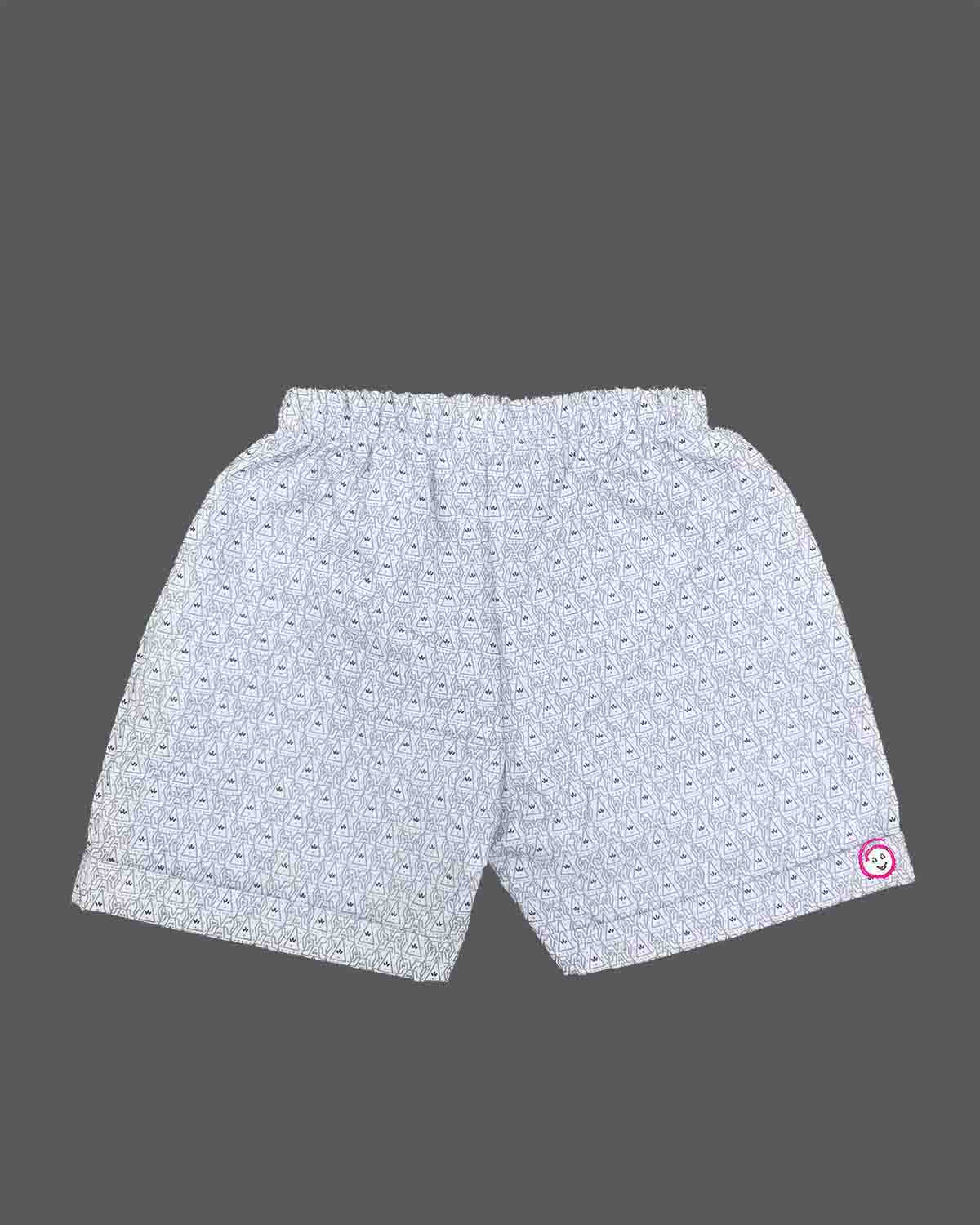 A matching casual shirt and shorts duo for young boys featuring an all-over patterned design and a comfortable elastic waistband.