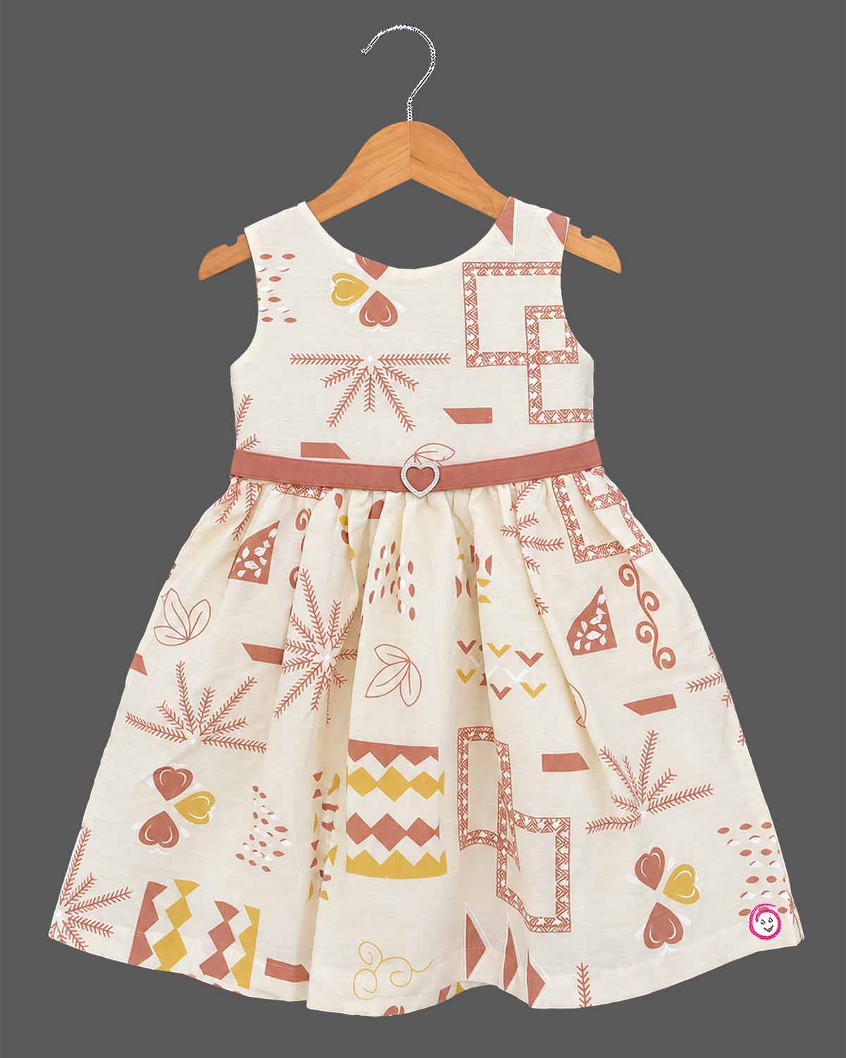 Little Girl Casual Frock featuring a cream dress with patterns and a peachish-pink textured shrug/jacket with a flower brooch and tie-up front.