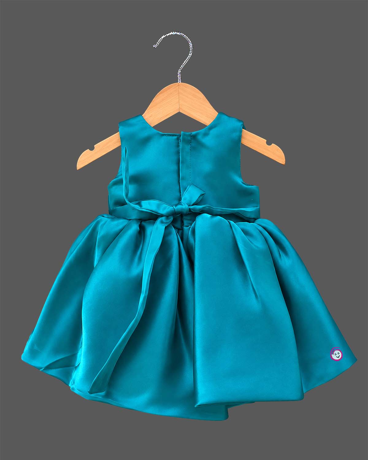 Teal blue satin party frock for toddler girls with large floral accents on shoulder and waist