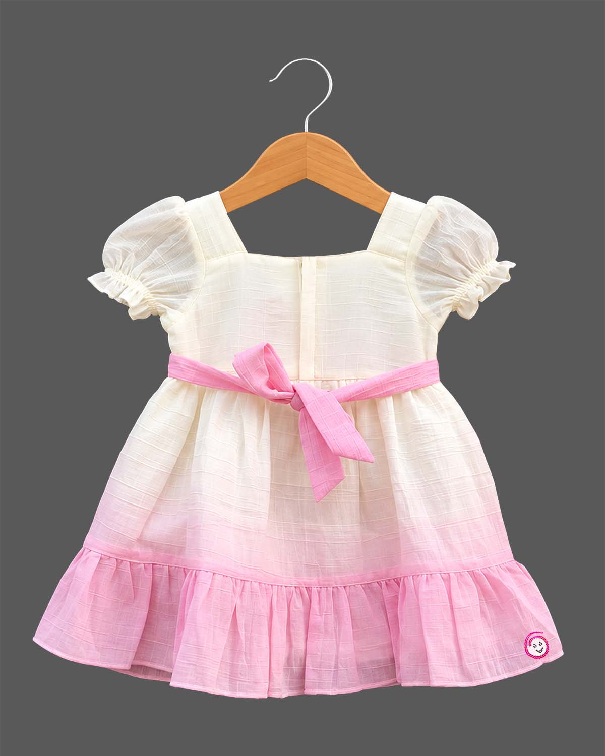 Toddler girls smocked bodice frock with puff sleeves, square neckline, and ric-rac trimmed ruffle hem.