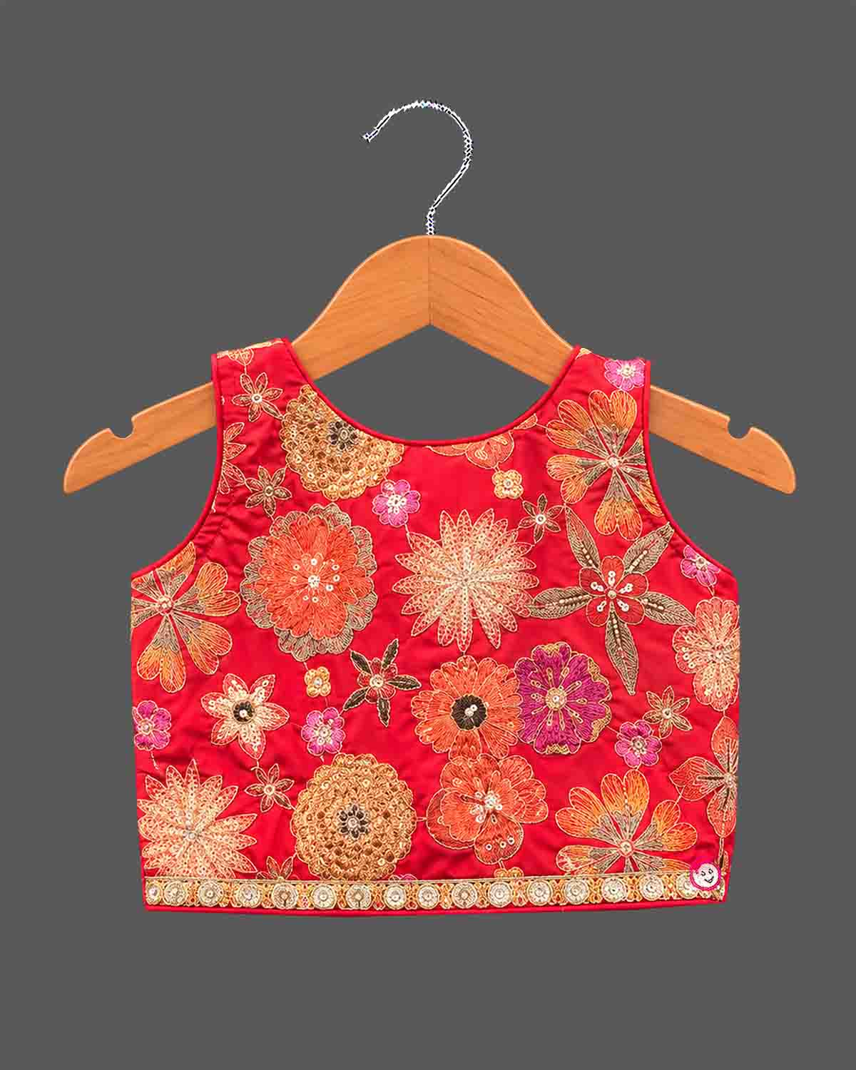 Girls floral embroidered sleeveless choli paired with a tiered ruffled skirt and tassel drawstring accent.