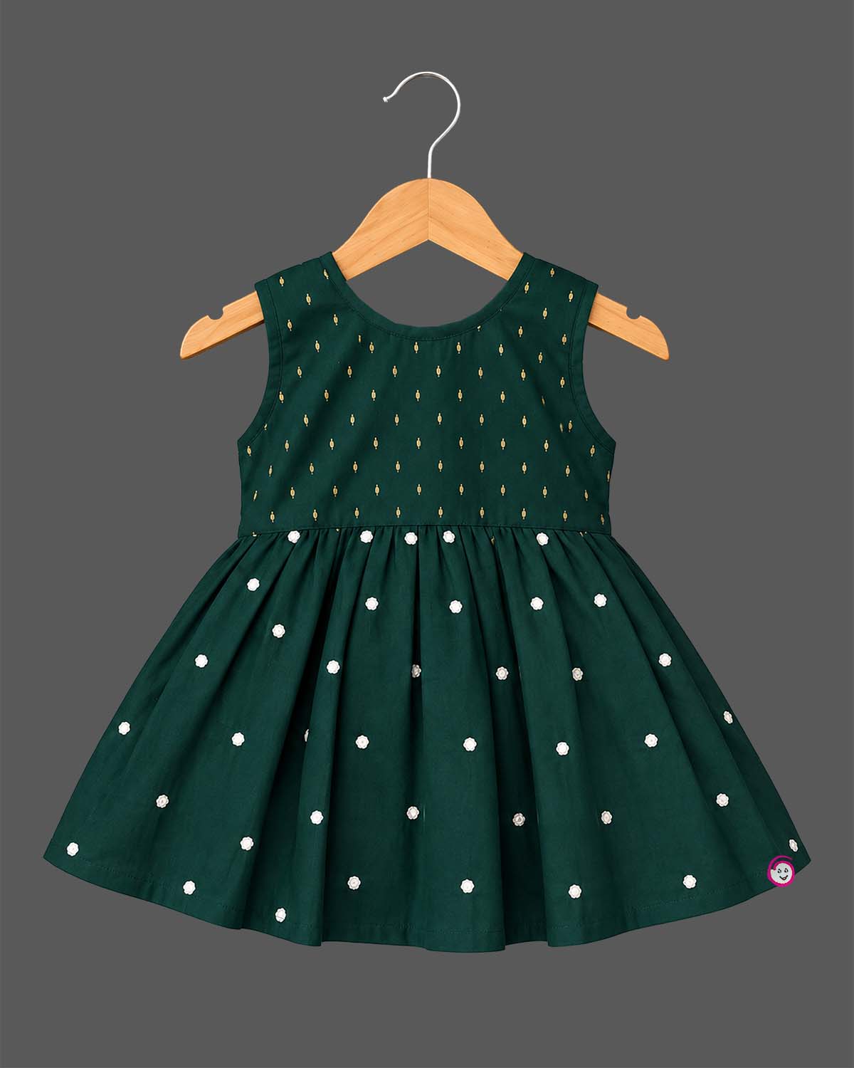 Sleeveless pattu frock with woven yoke detail and pleated floral flare for baby girls.