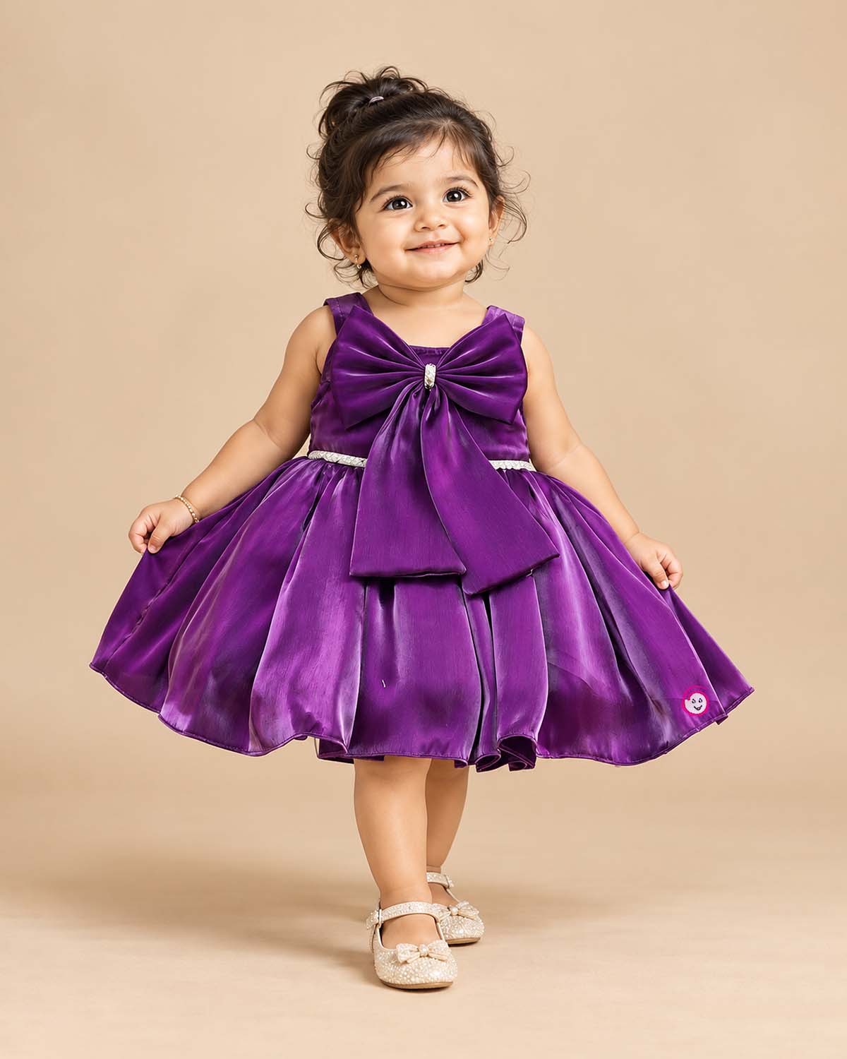 Baby party wear dress featuring a sleeveless satin fit and flare silhouette with front oversized bow and booties set.