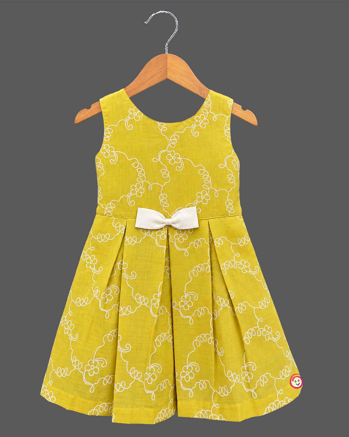 Toddler girl in mustard yellow cotton embroidered casual frock with off-white ruffled jacket