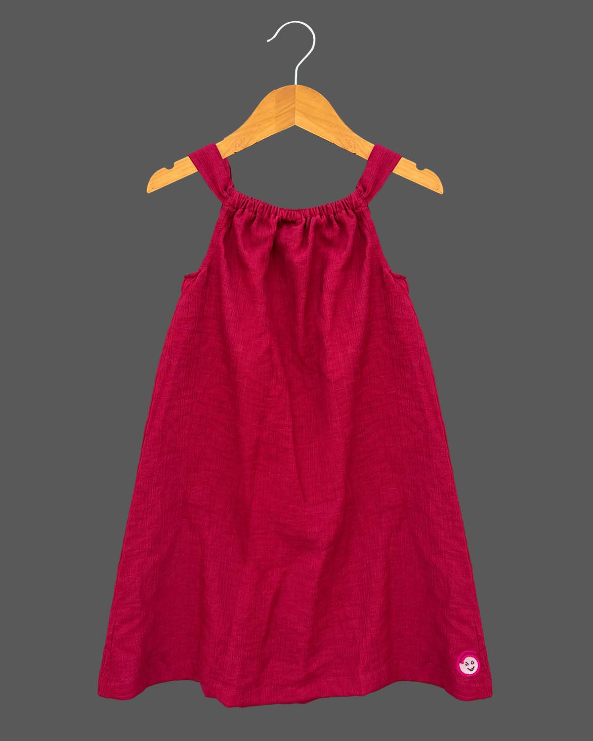 Baby girl lehenga style sleeveless dress with large floral appliques, soft textured weave, and flared silhouette.