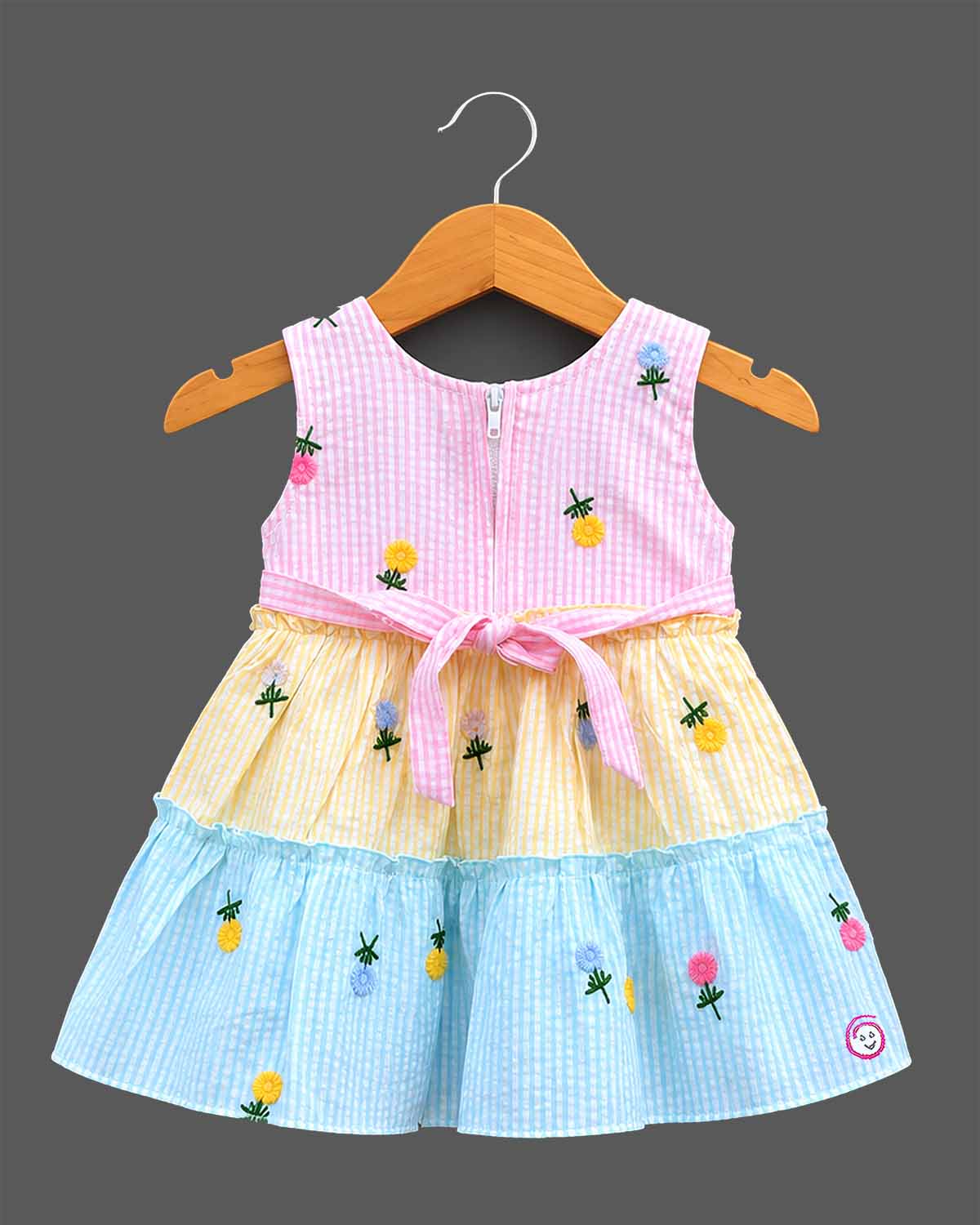 Sleeveless embroidered seersucker tiered frock with scoop neck and frill layers for toddlers.