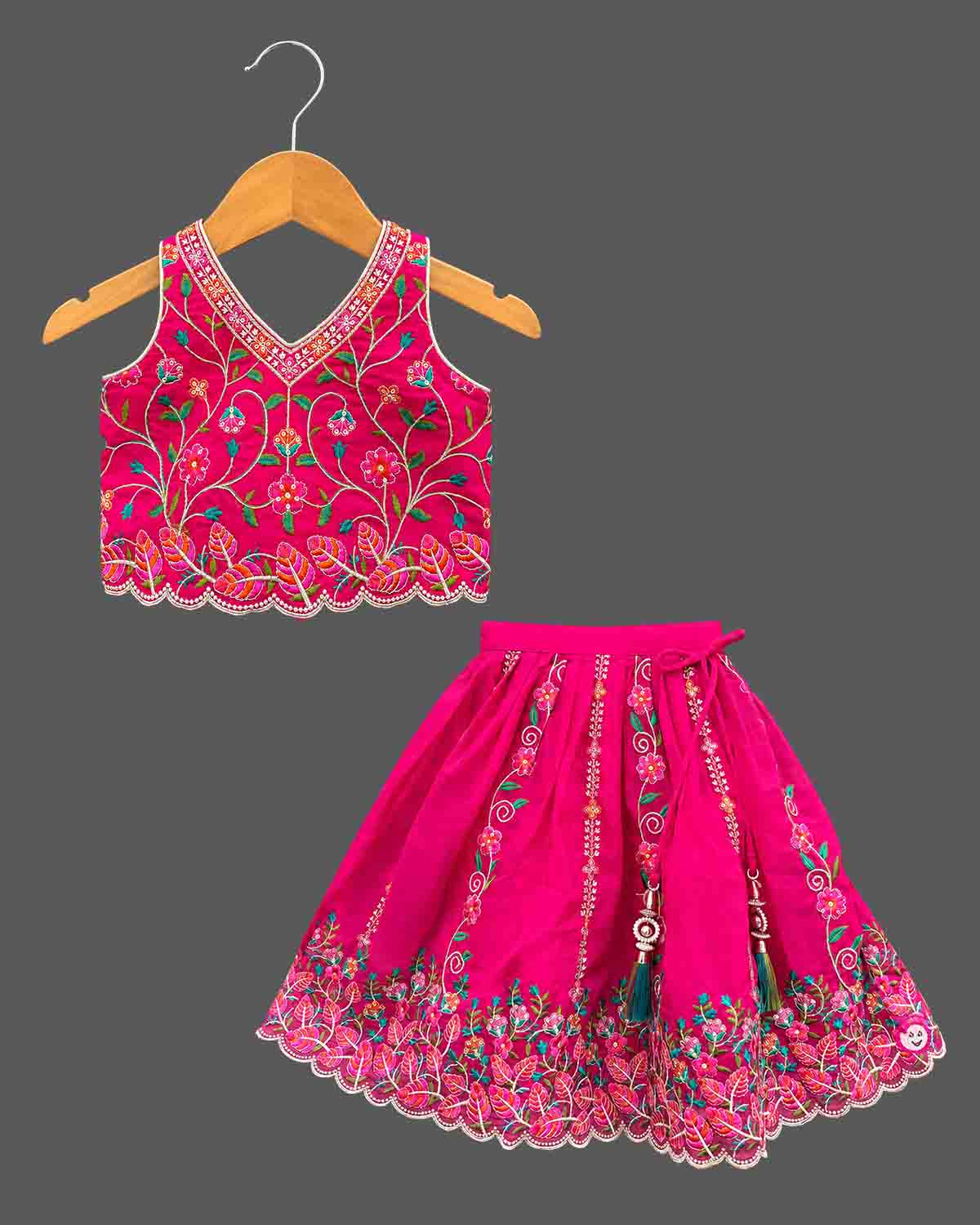 Detailed view of sleeveless embroidered lehenga choli for kids featuring scalloped floral hems.