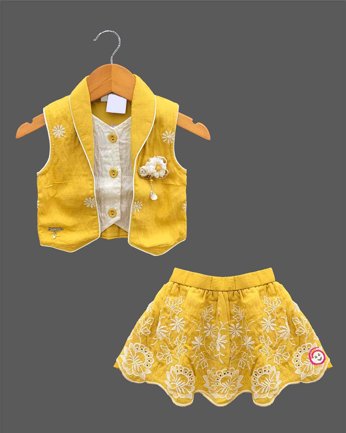 Baby girl in a stylish sleeveless western top and matching embroidered skirt set