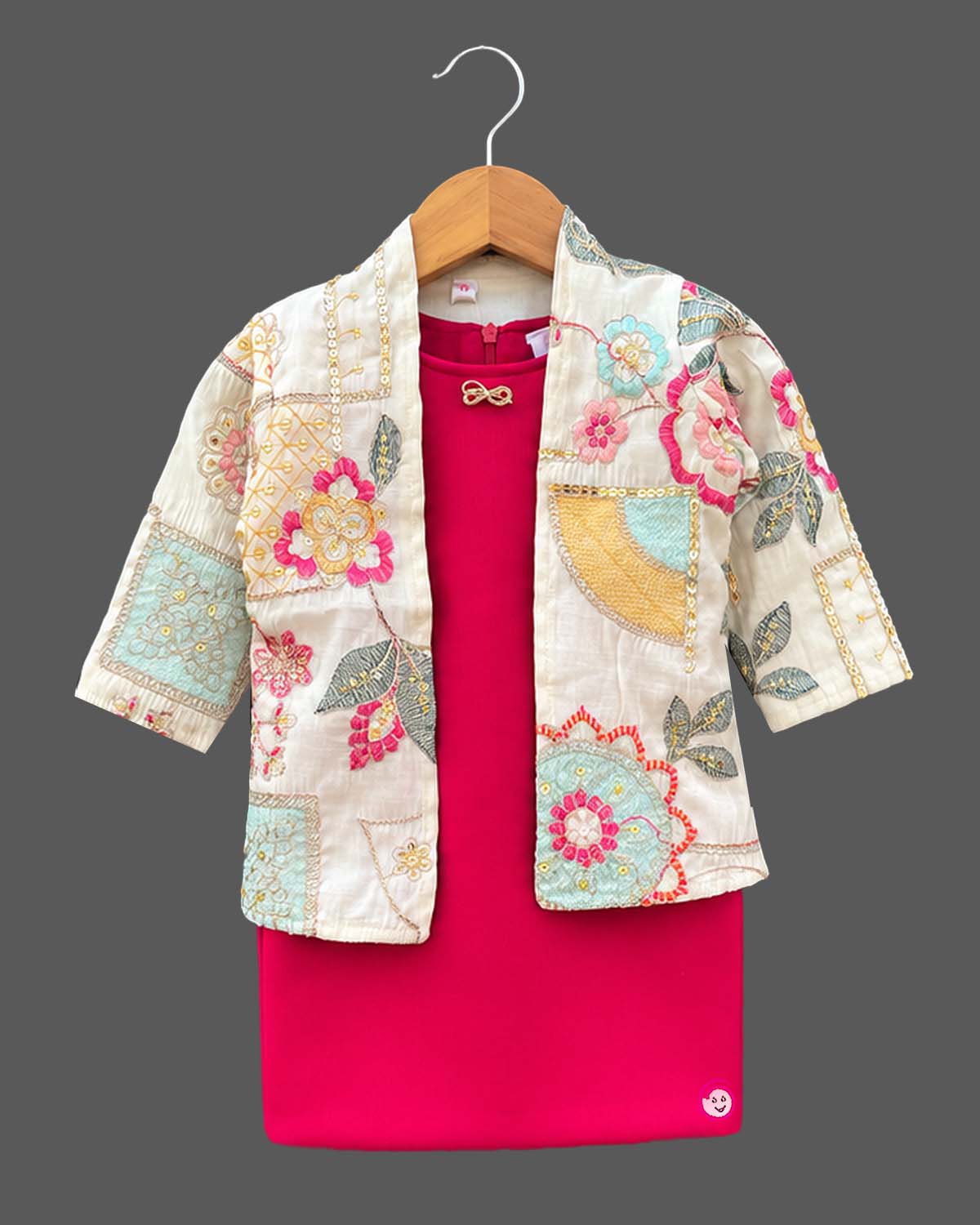 Baby party wear dress featuring a sleeveless midi inner and an open-front embroidered jacket.